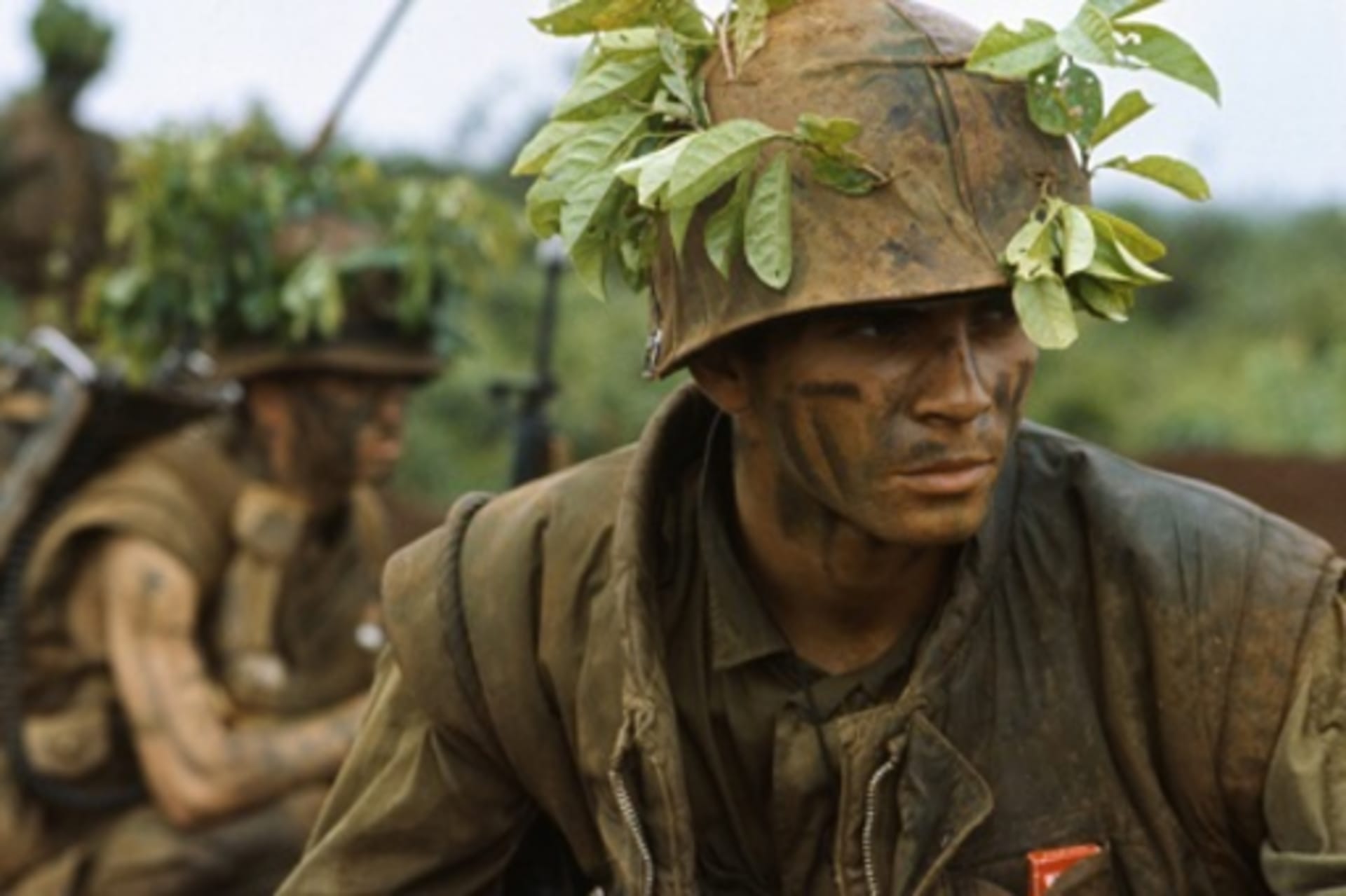 <p>U.S. Marines in camouflage move through low foliage in the Demilitarized Zone of Vietnam. </p>
