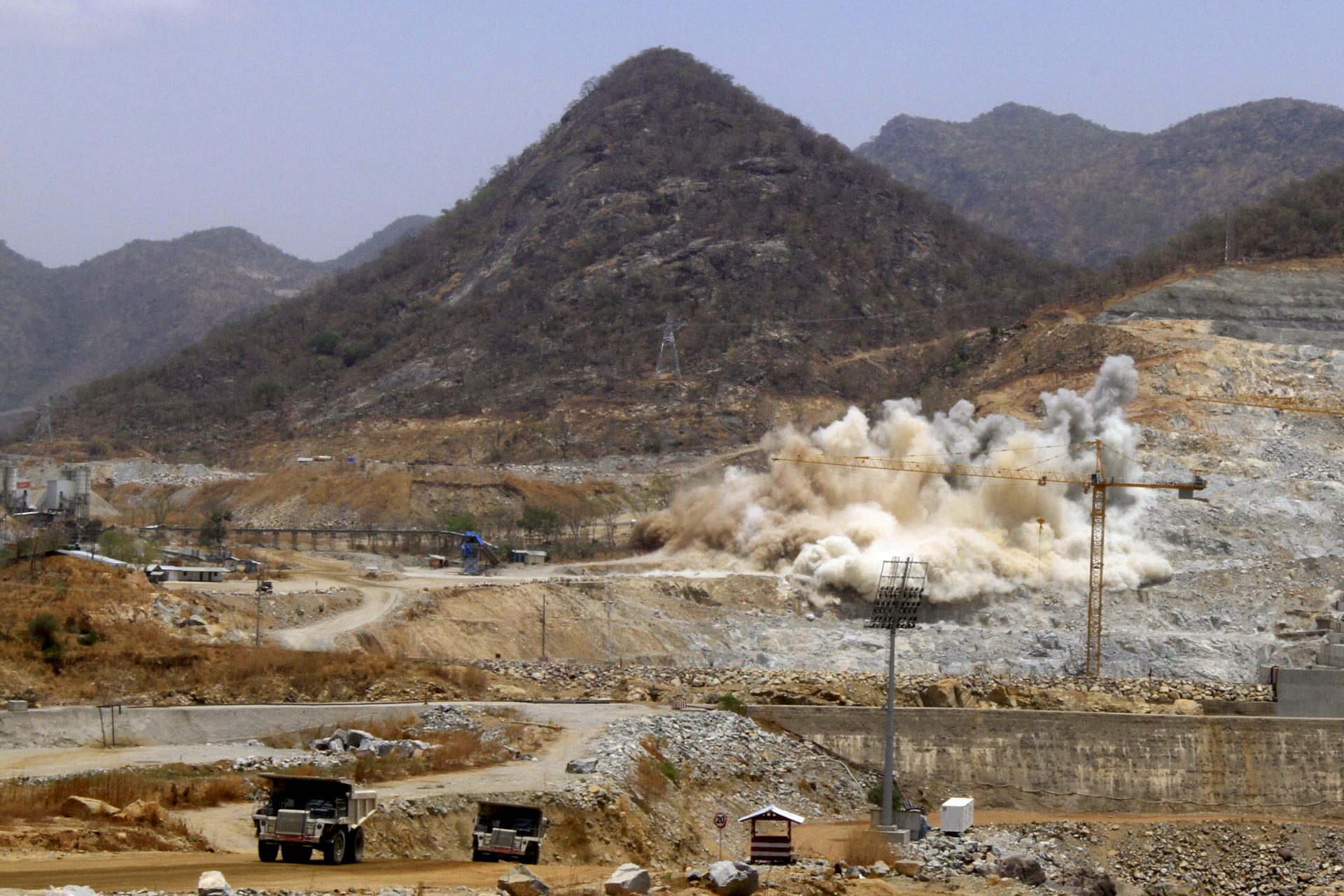 <p>A cloud of dust rises from a dynamite blast, as part of construction work, at Ethiopia’s Grand Renaissance Dam during a media tour along the river Nile in Benishangul Gumuz Region, Guba Woreda, in Ethiopia (Tiksa Negeri/Reuters).</p>