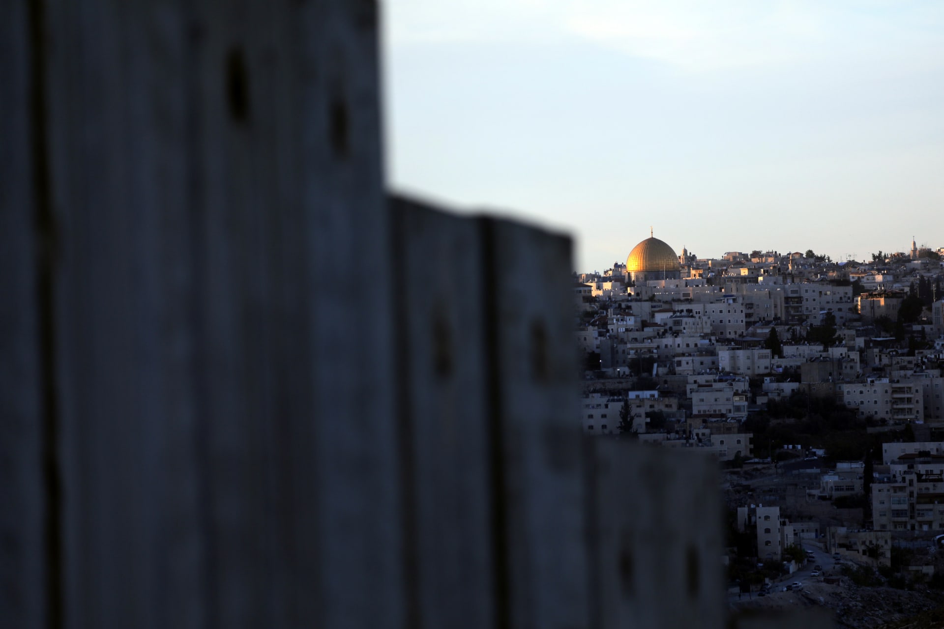 <p>The Dome of the Rock and Jerusalem’s Old City can be seen over the Israeli barrier from the Palestinian town of Abu Dis in the West Bank (Ammar Awad/Reuters).</p>
