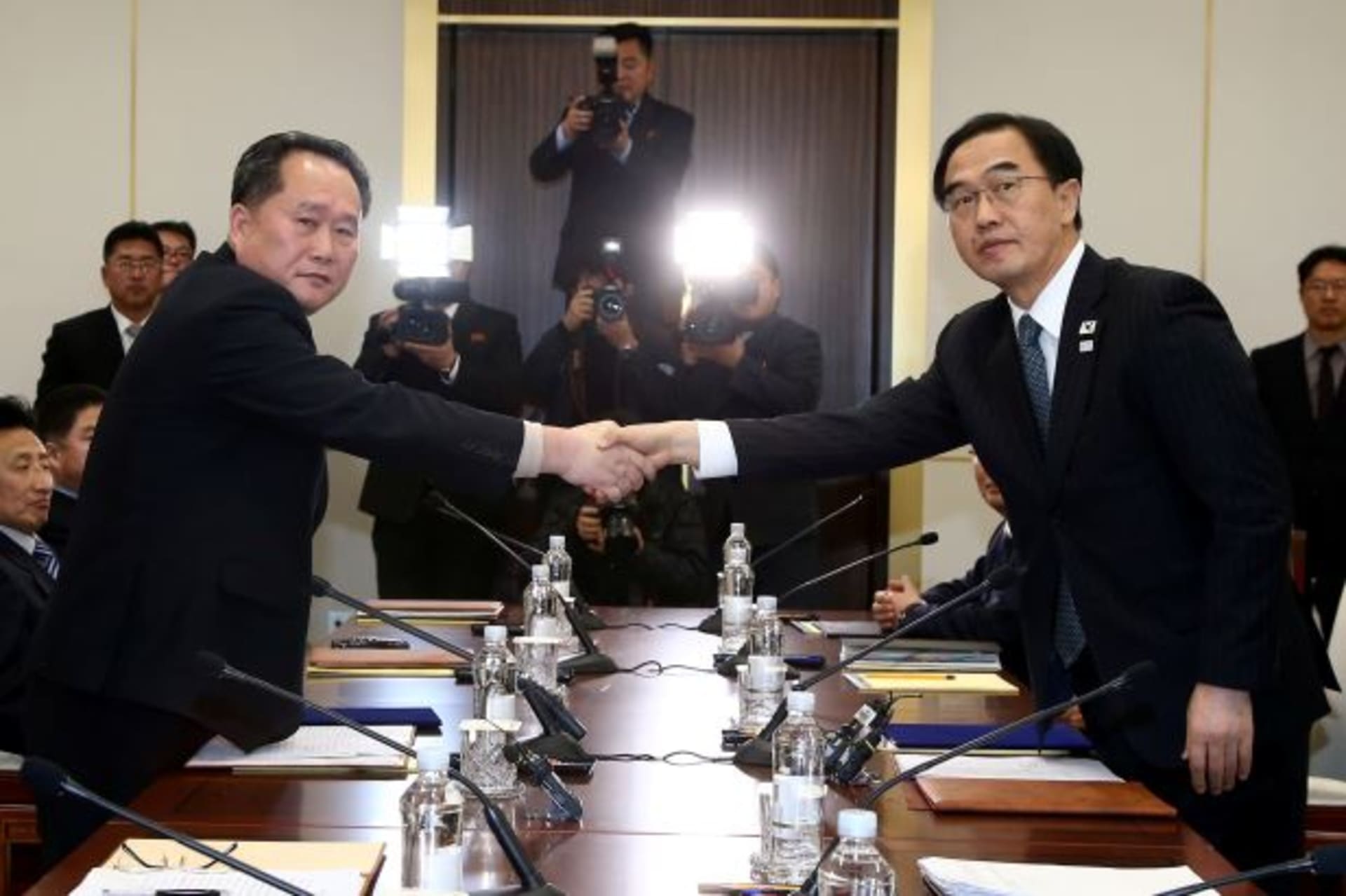 <p>Head of the North Korean delegation, Ri Son Gwon shakes hands with South Korean counterpart Cho Myoung-gyon as they exchange documents after their meeting at the truce village of Panmunjom in the demilitarised zone separating the two Koreas.</p>

