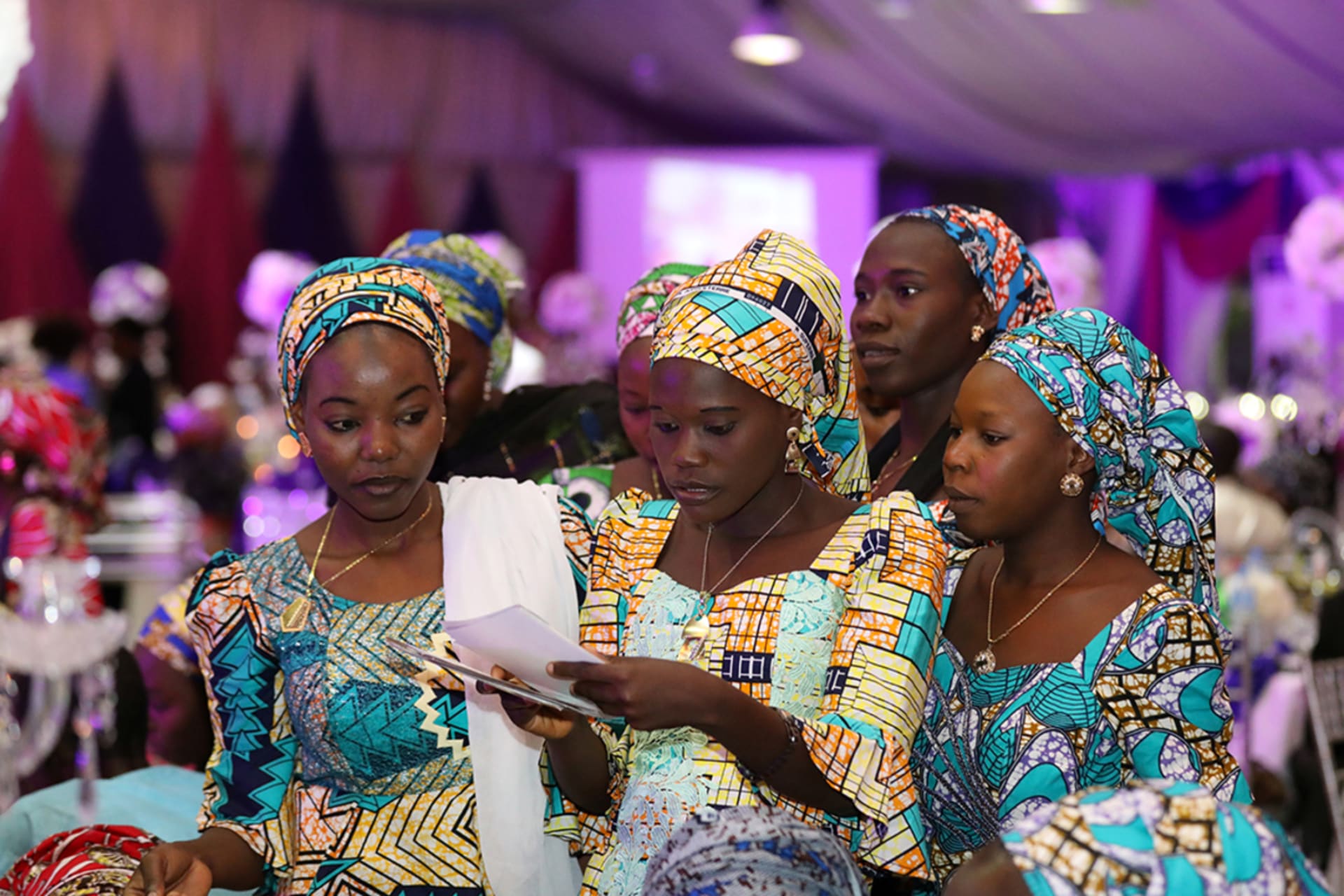 <p>Some of the 106 girls who were kidnapped by Boko Haram militants in the Nigerian town of Chibok look through a set of photographs during the the send-forth dinner organised for them in Abuja, Nigeria September 13, 2017.</p>
