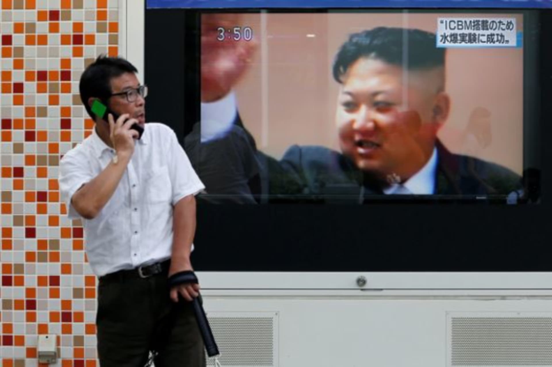 <p>A man walks past a street monitor showing North Korea’s leader Kim Jong-Un in a news report about North Korea’s nuclear test, in Tokyo, Japan, September 3, 2017.</p>
