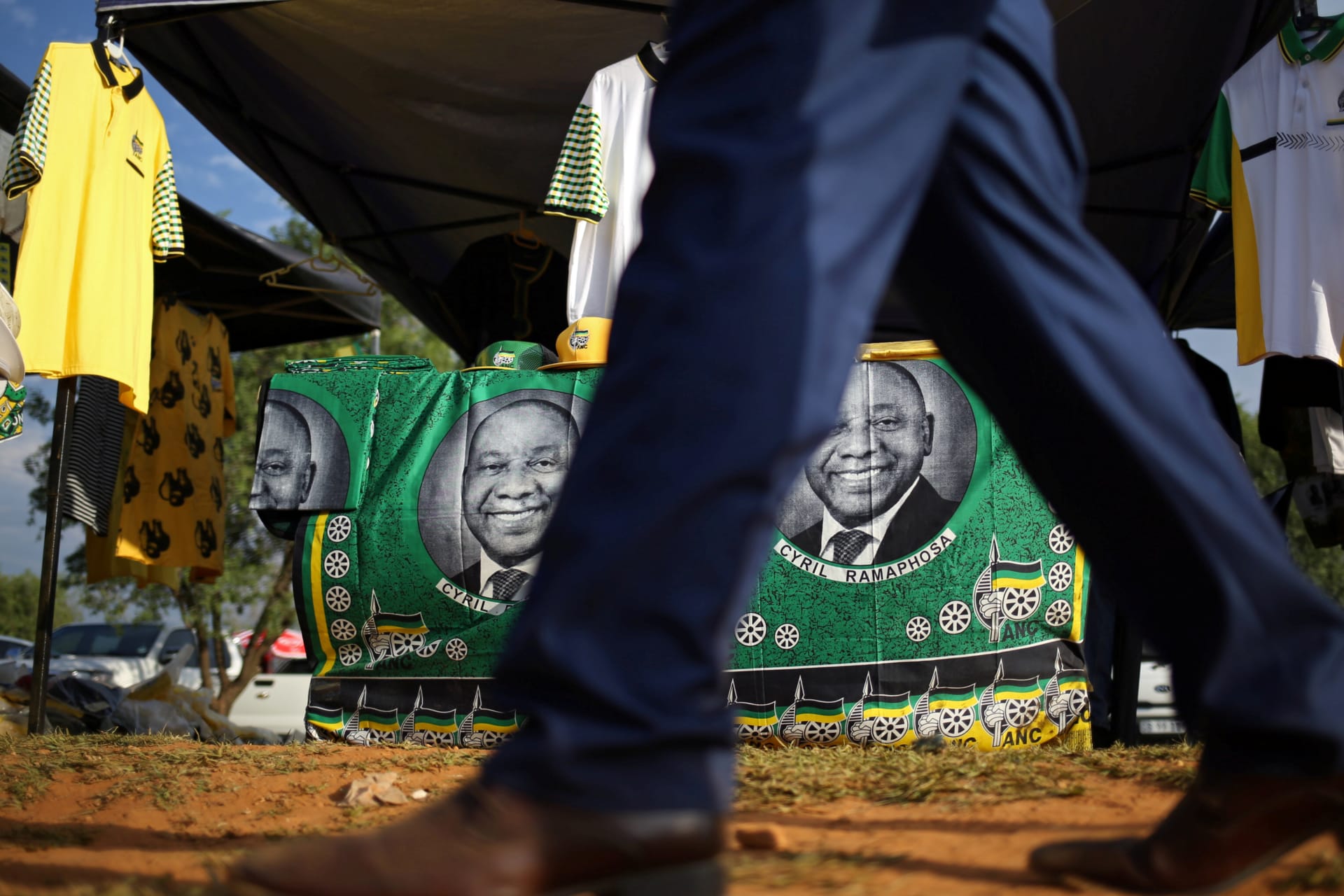 <p>A man walks past ANC merchandise with the face of newly elected president Cyril Ramaphosa outside the venue of the 54th National Conference of the ruling African National Congress (ANC) at the Nasrec Expo Centre in Johannesburg, South Africa.</p>
