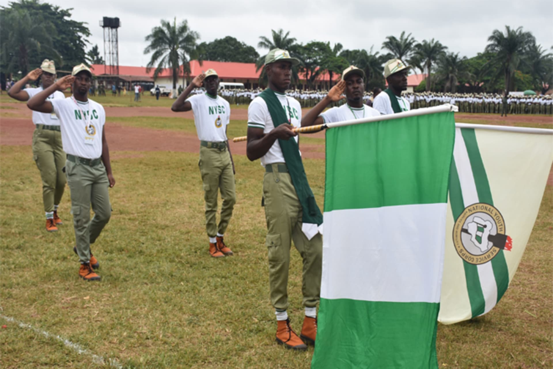<p>National Youth Service Corps (NYSC) members display the Nigerian and NYSC flags during a parade in Nigeria.</p>
