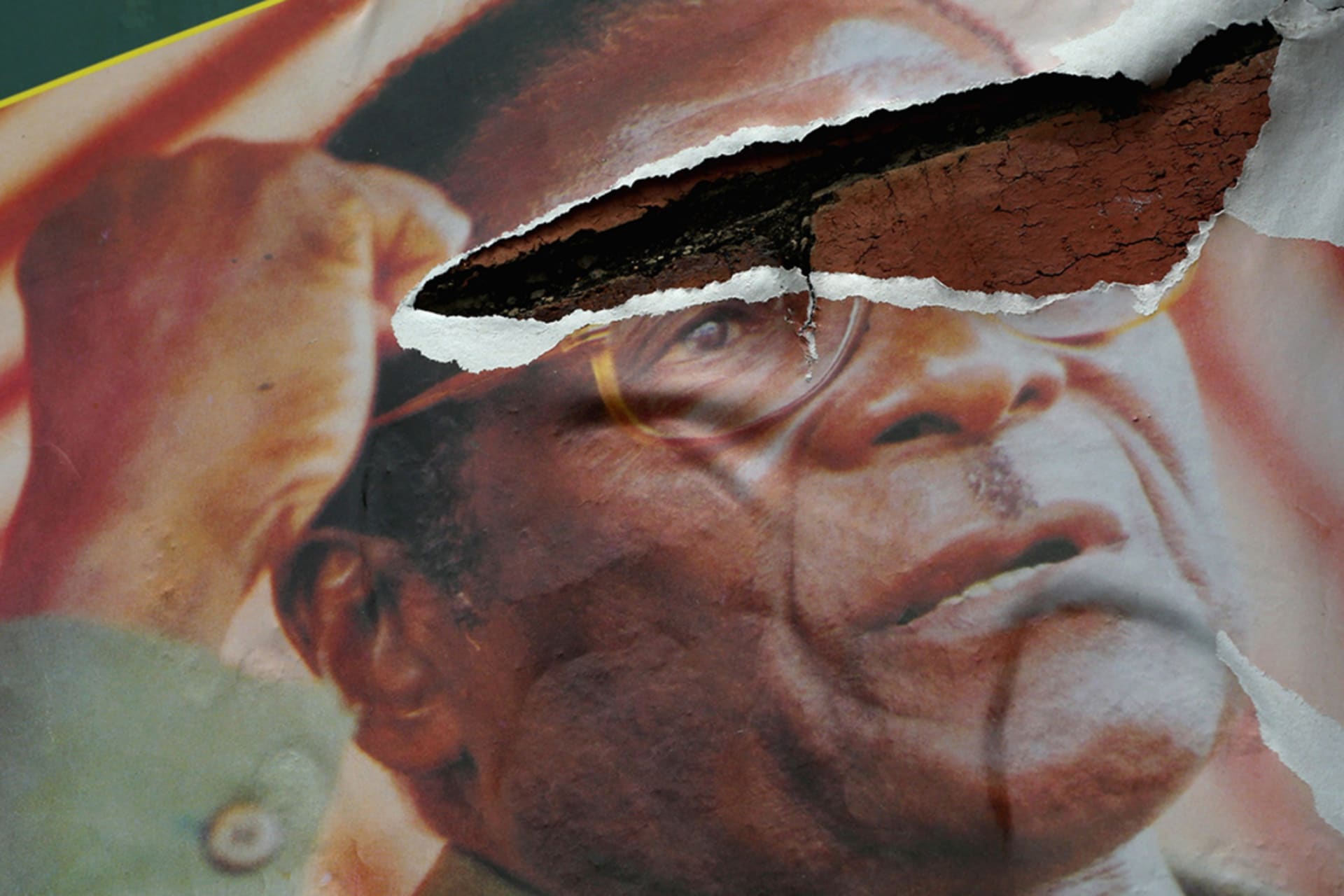 <p>A poster of President Robert Mugabe hangs torn on a streetside wall in Bulawayo, Zimbabwe.</p>
