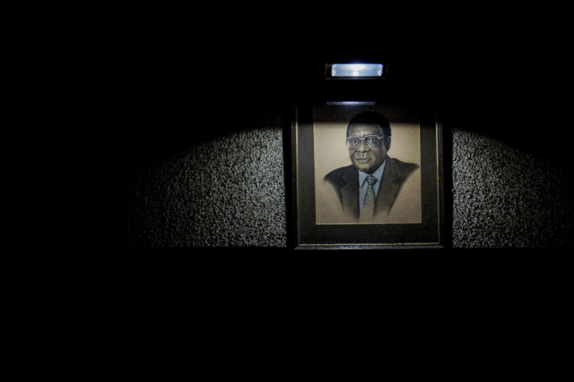 <p>A portrait of Zimbabwe’s President Mugabe hangs in the ZANU-PF hall where delegates sat for a special meeting of the party on November 19 in Harare. Mugabe faces the collapse of his 37-year regime, with the party set to impeach him. </p>
