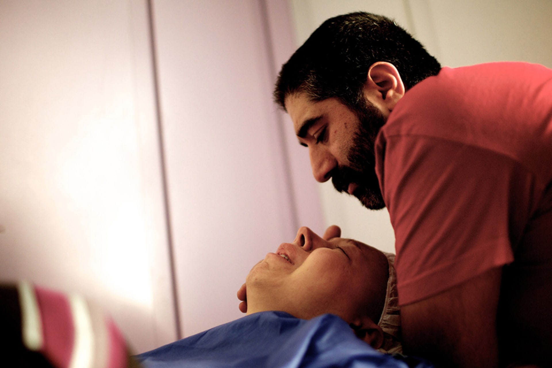 <p>A man comforts his fiancée, a patient at a breast cancer clinic in Tehran, Iran. With little access to preventive and primary care, working-age people in poorer nations are more likely to develop and receive late diagnoses for cancers and other NCDs.</p>
