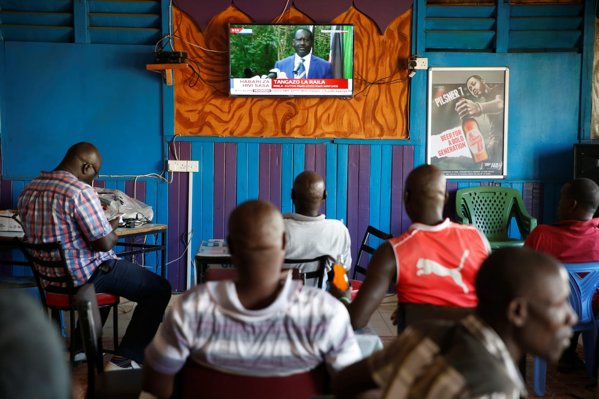 <p>People in a bar watch Kenyan opposition leader of the NASA coalition Raila Odinga’s news conference in Kisumu, Kenya October 31, 2017. In it, he announced the creation of a People’s Assembly to govern Kenya until new elections can be held.</p>
