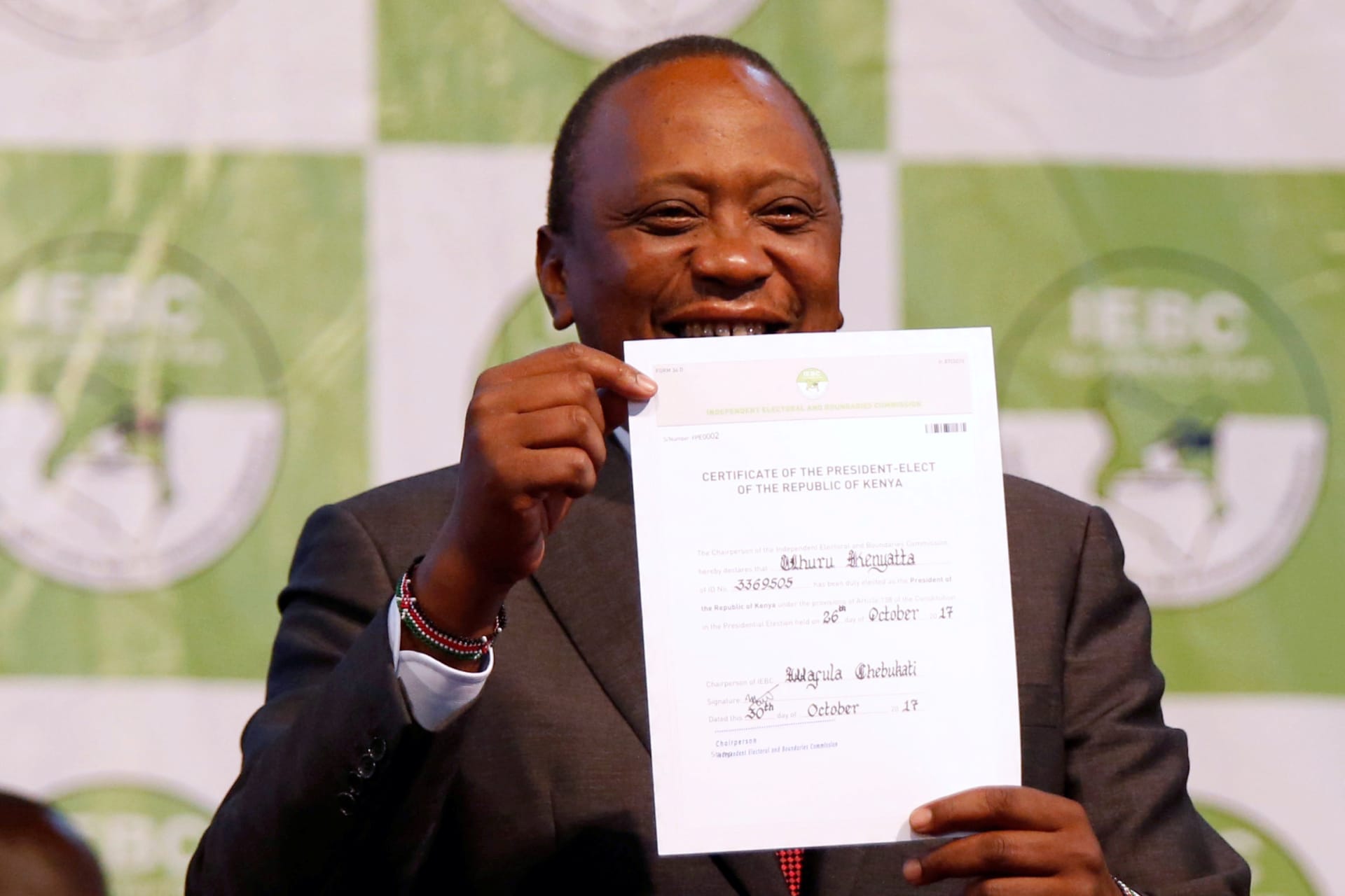 <p>Incumbent President Uhuru Kenyatta holds the certificate of President-Elect of the Kenya after he was announced winner of the repeat presidential election at the IEBC National Tallying centre at the Bomas of Kenya, in Nairobi, Kenya October 30, 2017.</p>
