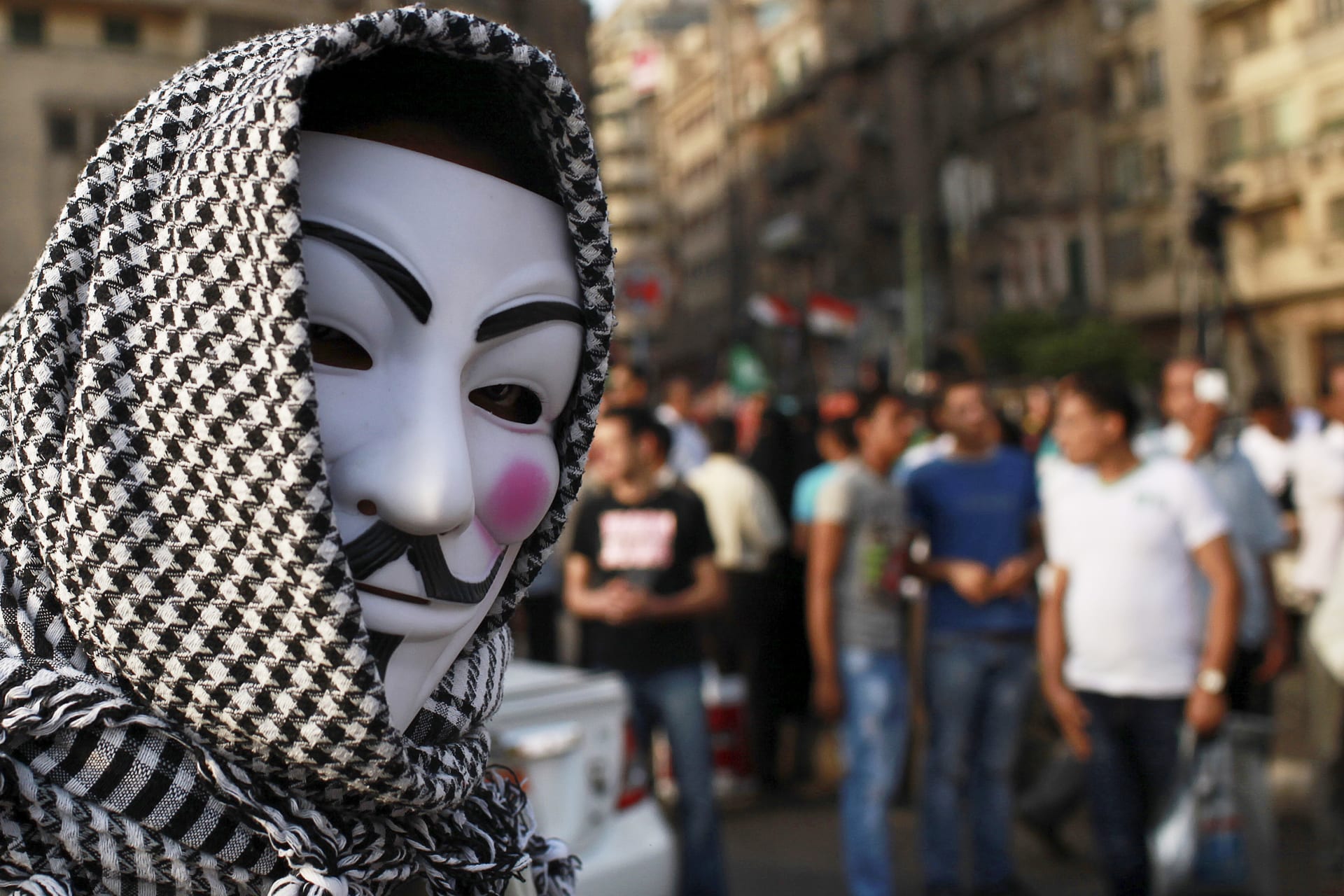 <p>A protester wearing a Guy Fawkes mask attends a demonstration against presidential candidates Mohamed Mursi and Ahmed Shafiq at Tahrir Square in Cairo May 29, 2012. </p>
