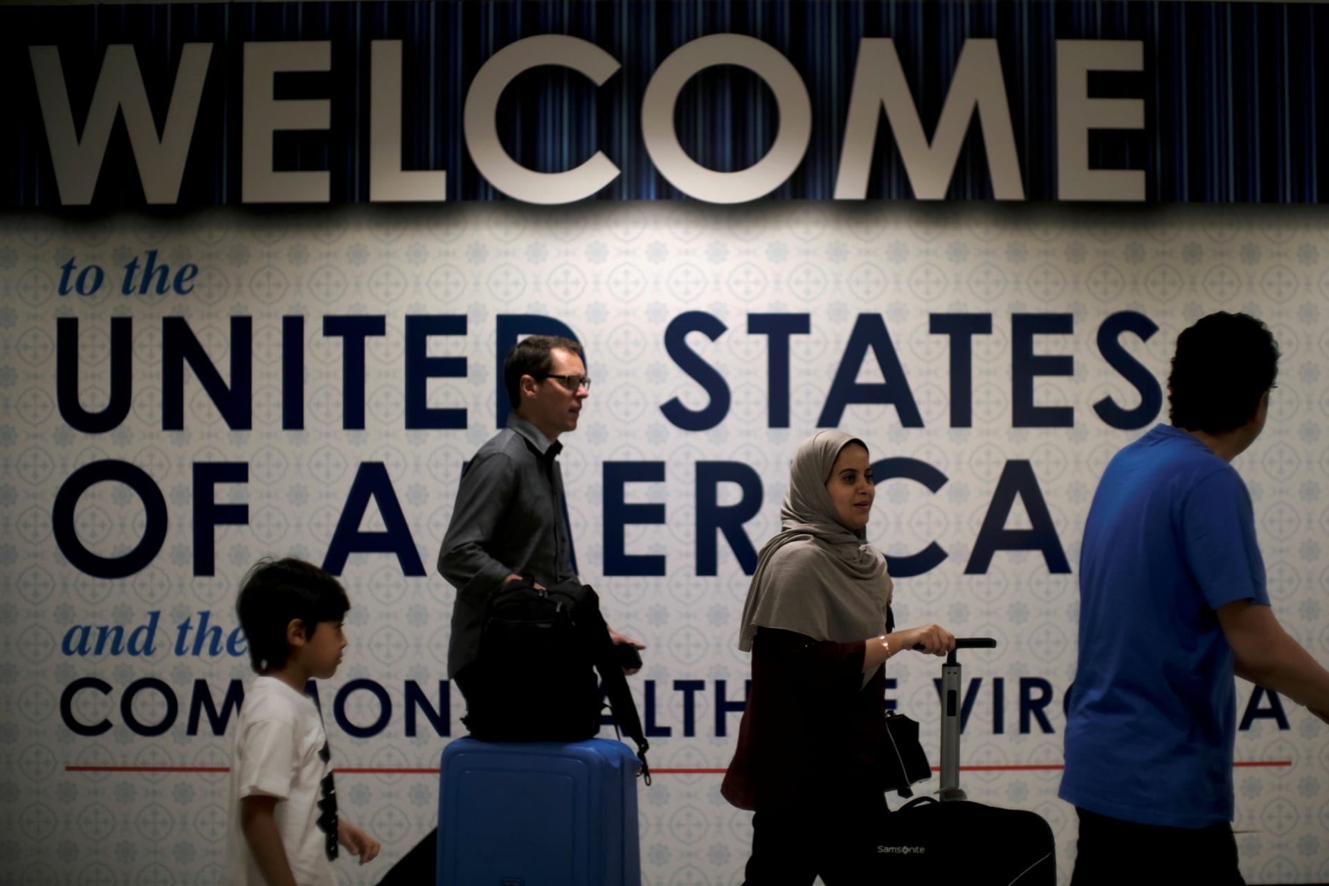 <p>International passengers arrive at Washington Dulles International Airport after the U.S. Supreme Court granted parts of the Trump administration’s emergency request to put its travel ban into effect in June, pending further judicial review </p>