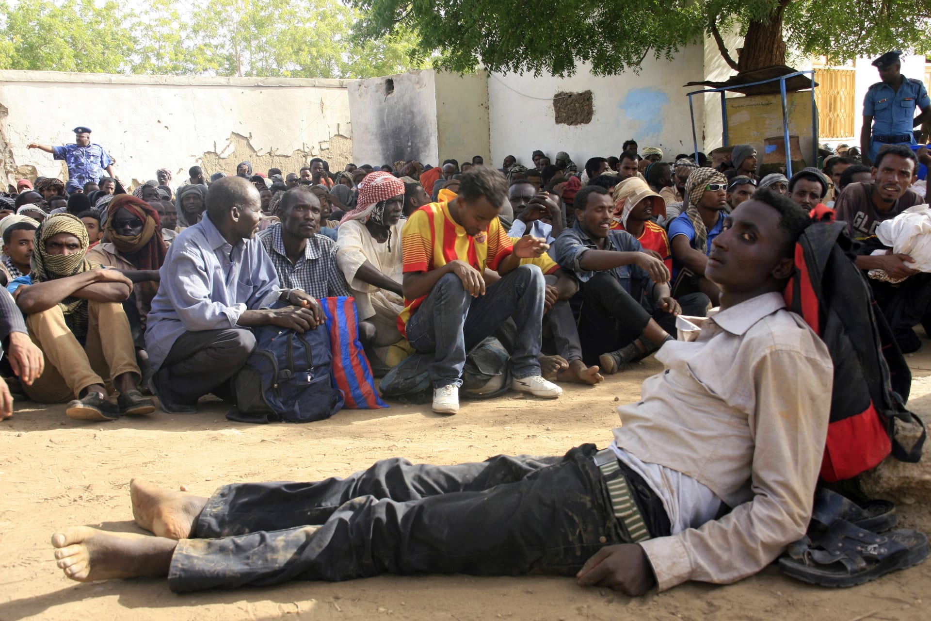 <p>Illegal immigrants who were abandoned by traffickers in a remote desert area wait in Dongola, Sudan, after being located by Sudanese and Libyan forces, May 3, 2014. Sudan is Tier 3 and Libya, a “special case,” because it is a war zone.</p>
