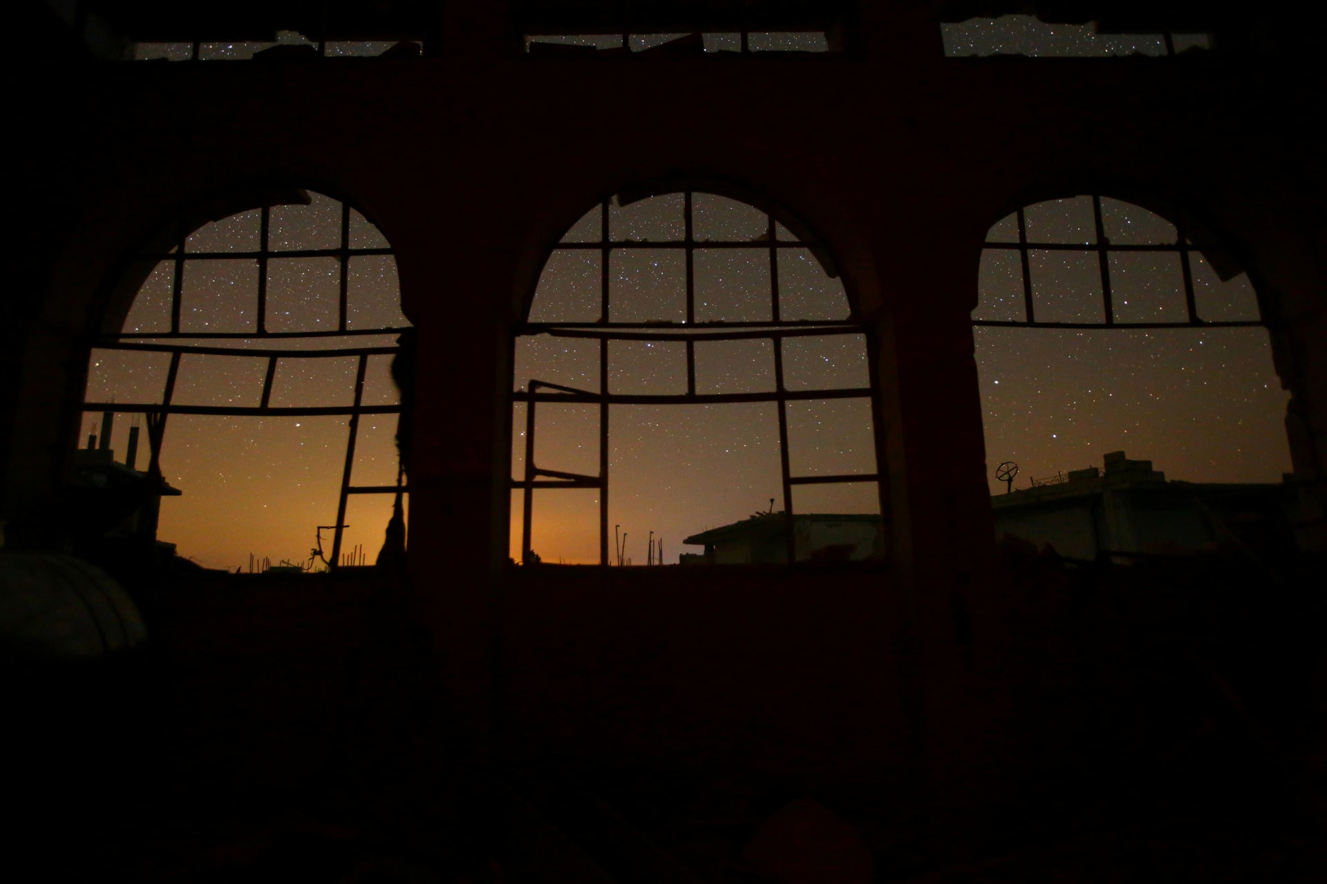 <p>The night sky is seen through damaged windows in the rebel-controlled town of Binnish in Idlib province, Syria September 7, 2016 (REUTERS/Ammar Abdullah)</p>
