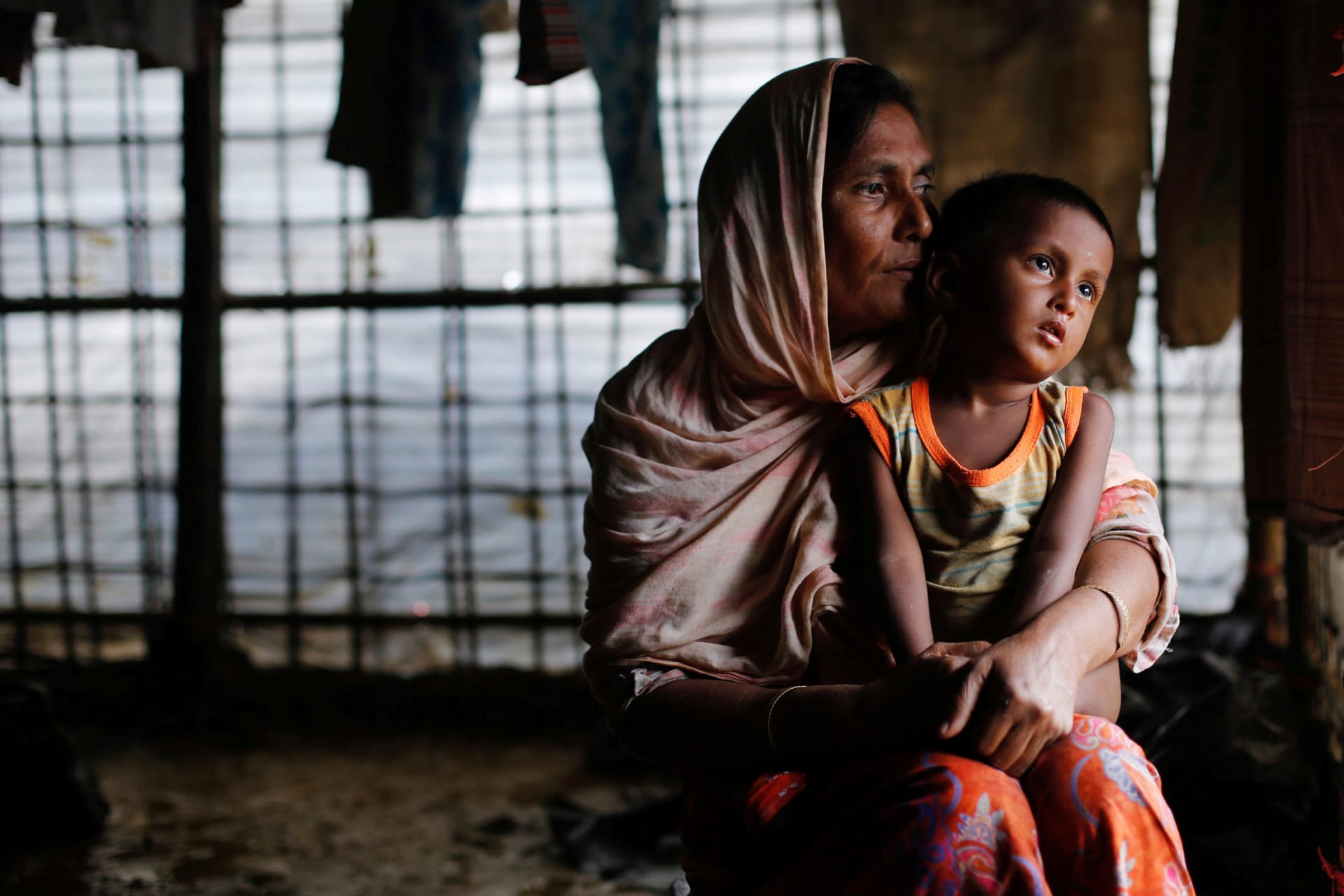 <p>A Rohingya refugee woman waits for aid with her grandson inside their temporary shelter at a camp in Cox’s Bazar, Bangladesh September 19, 2017. </p>