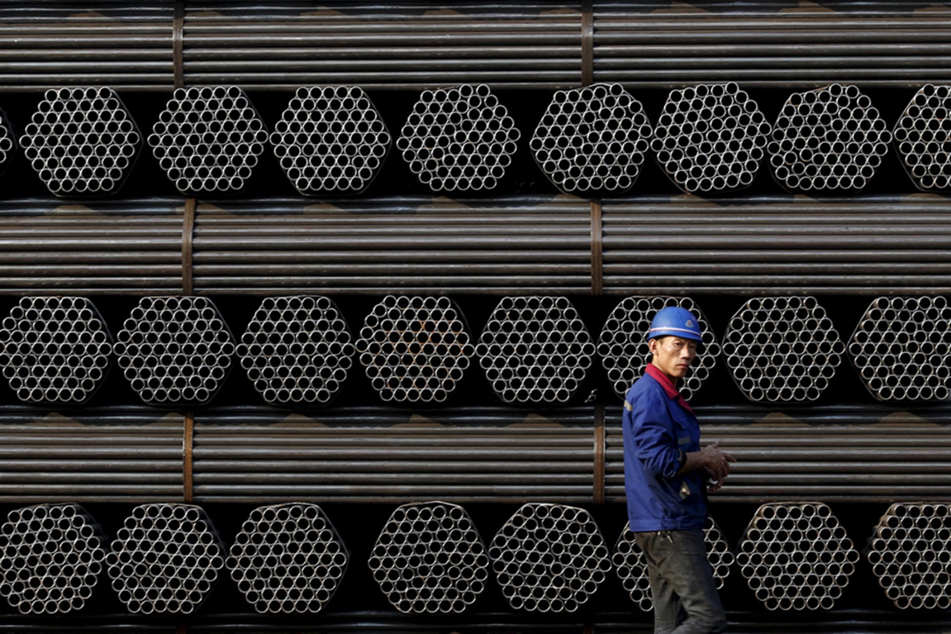 <p>A worker stands in front of steel piping at a plant in China’s Hebei Province.</p>
