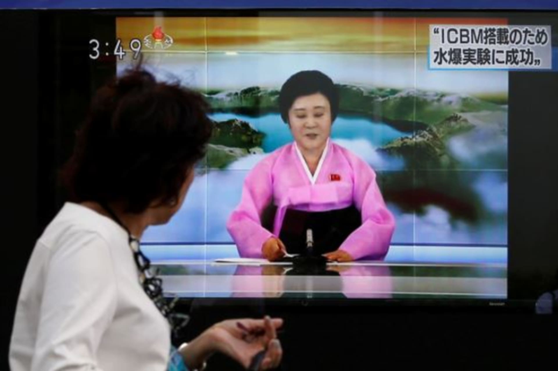 <p>People walk past a street monitor showing a news report about North Korea’s nuclear test in Tokyo, Japan, September 3, 2017.</p>
