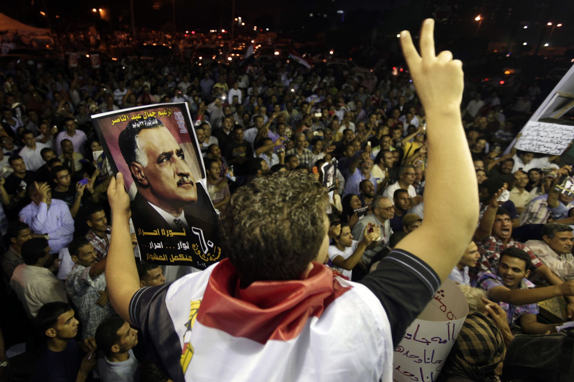 <p>A protester holds up a poster with an image of former Egypt president Gamal Abdel Nasser during the anniversary of the 1952 Egyptian revolution at Tahrir Square in Cairo (Mohamed Abd El Ghany/Reuters).</p>
