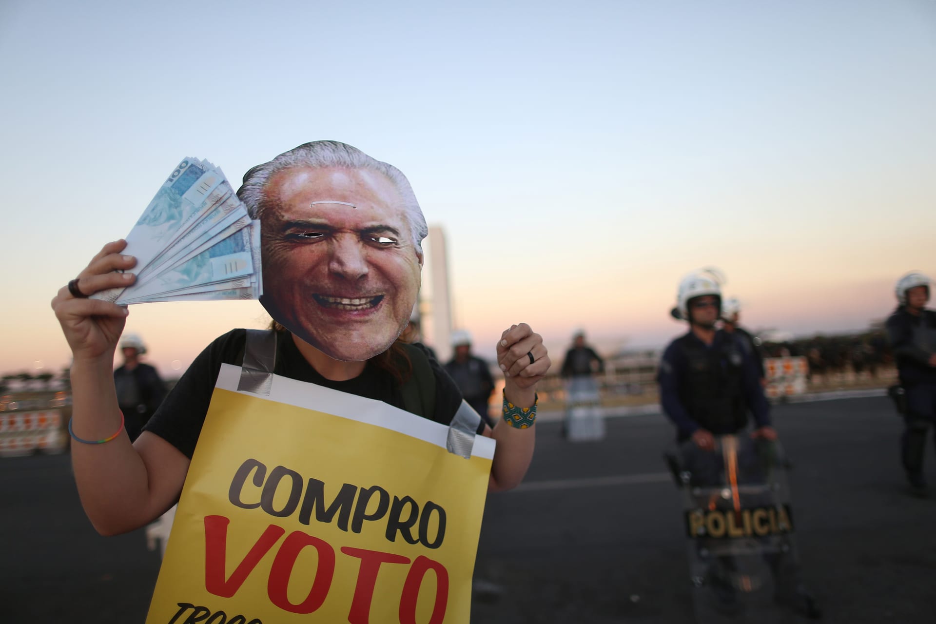 <p>A demonstrator protests with a face mask of Brazil’s President Michel Temer during a vote on sending corruption charges against Temer to the Supreme Court for trial in Brasilia. </p>
