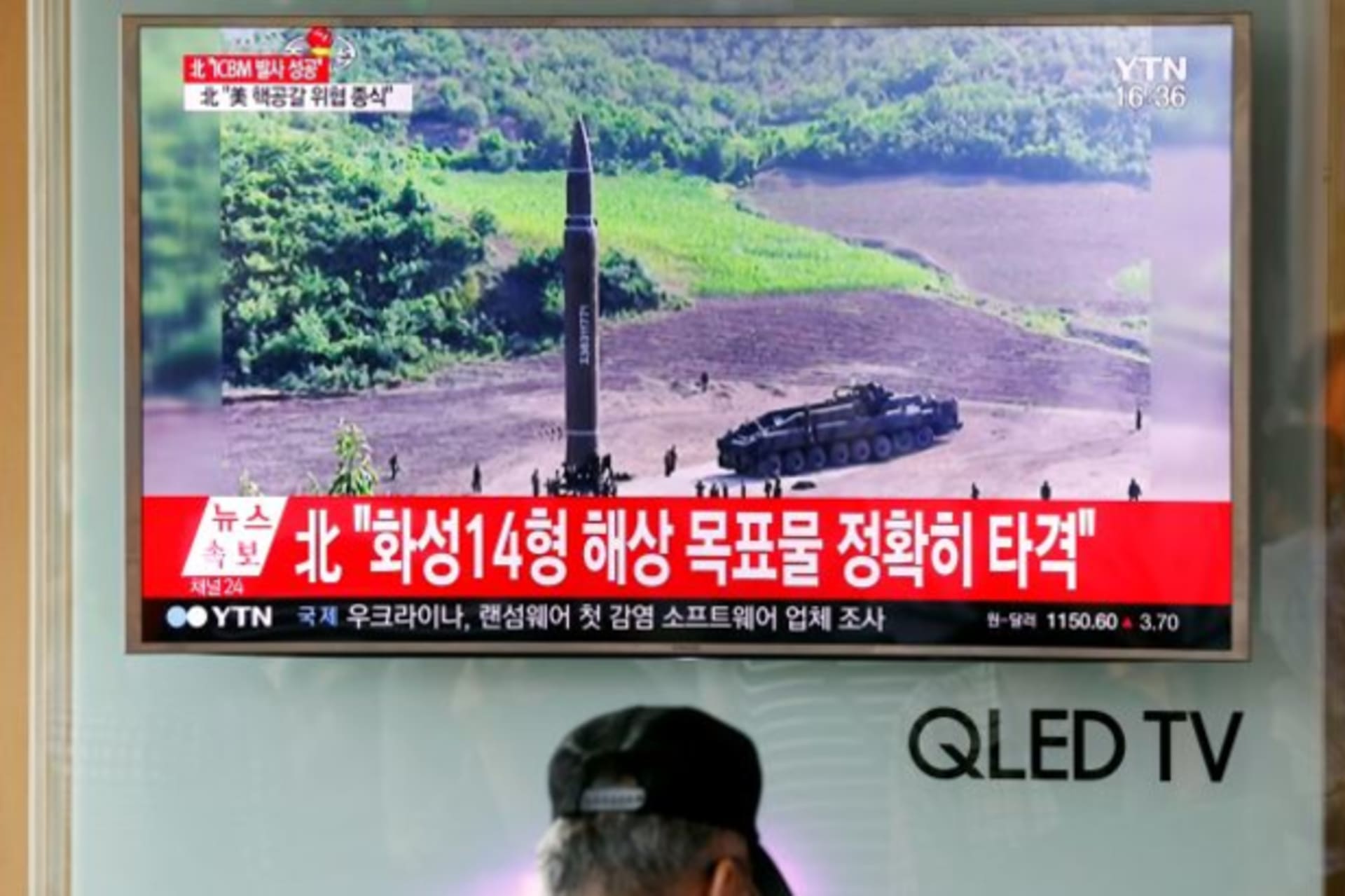 <p>A man watches a TV broadcasting still photographs released by North Korea’s state-run television KRT of North Korea’s Hwasong-14 missile, a new intercontinental ballistic missile, which they said was successfully tested, at a railway station in Korea.</p>
