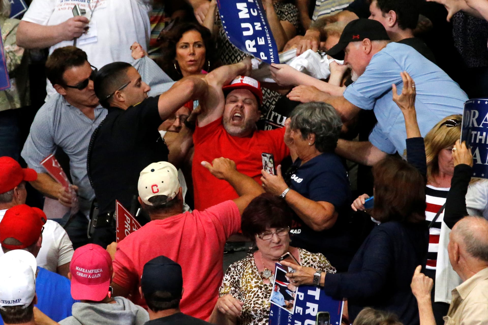<p>A protester is removed from a rally with U.S. President Donald Trump and supporters.</p>
