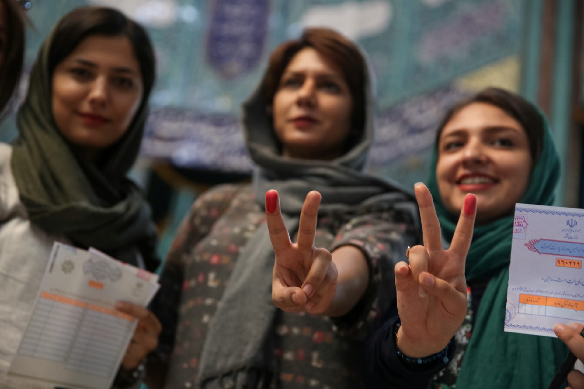 <p>Iranian women show their ink-stained fingers after casting their votes during the presidential election in Tehran, Iran, May 19, 2017. </p>
