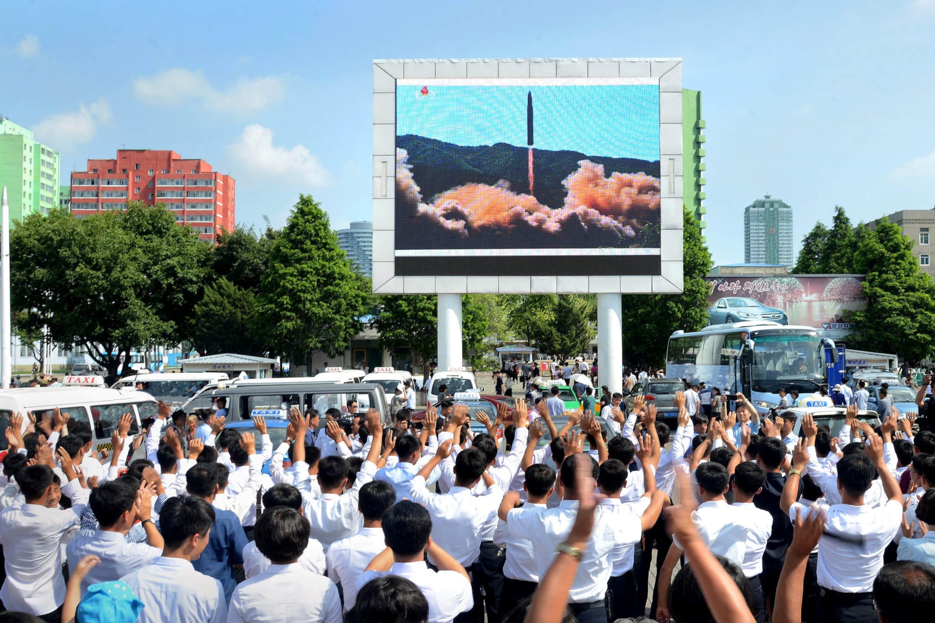 <p>North Koreans watch the test launch of the Hwasong-14 intercontinental ballistic missile.</p>

