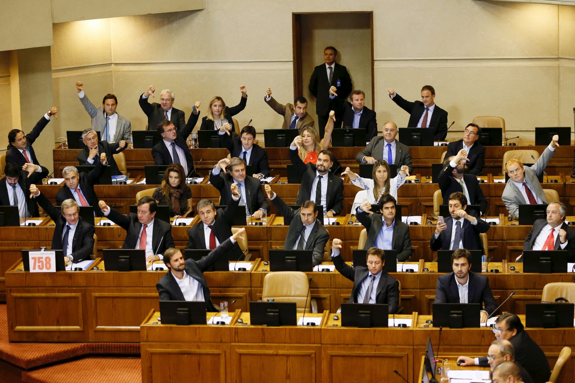<p>Deputies of right-wing party gesture in a sign of rejection during a session at the congress for a draft law of the government, which seeks to ease the country’s strict abortion ban, in Valparaiso, Chile March 17, 2016.</p>
