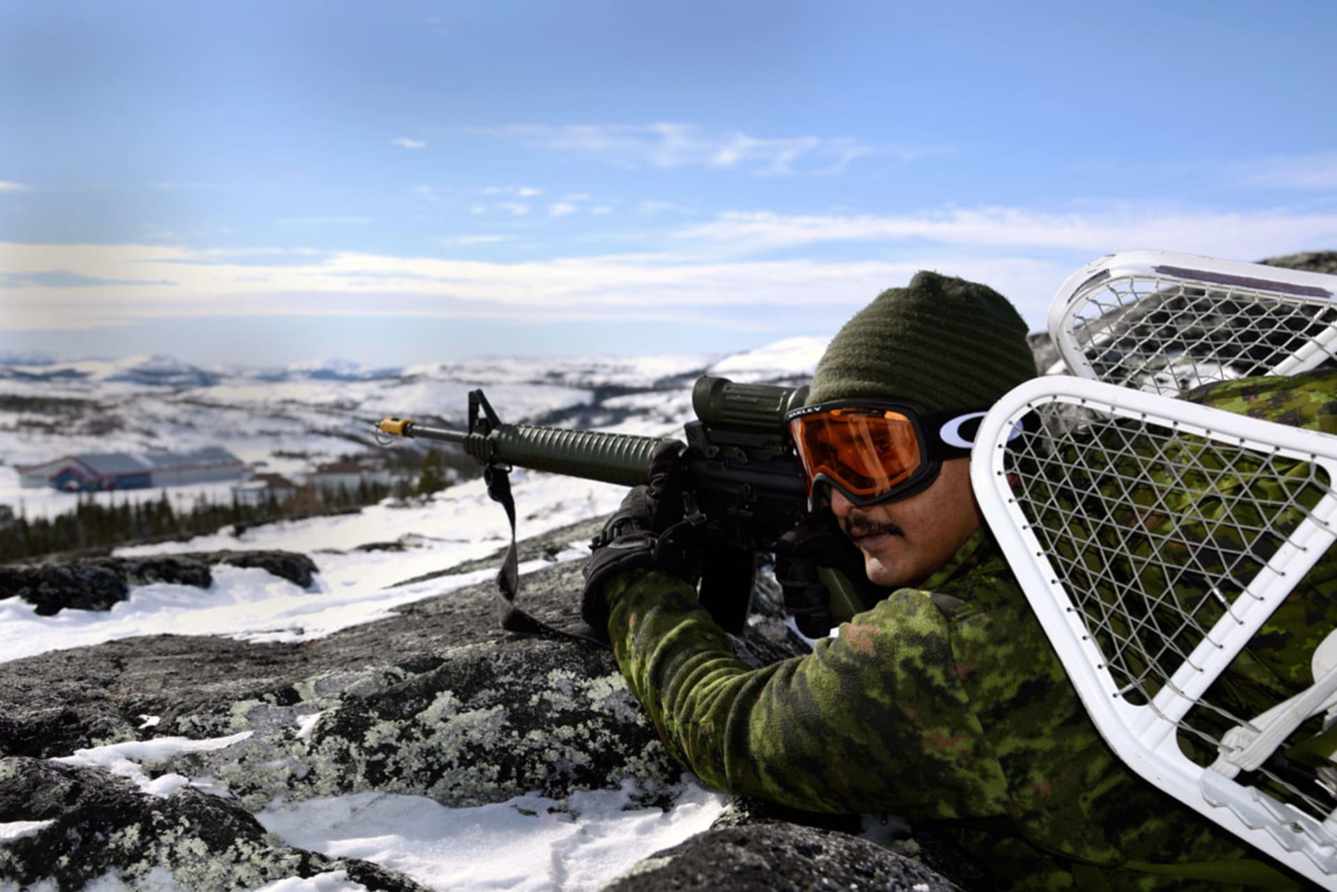 <p>A presence patrol made up of soldiers from 4th Artillery Regiment (General Support) make their way along the hills high above the town of Makkovik Labrador as part of Ex #NORHTERNSOJOURN, on 7 March 2017.</p>
