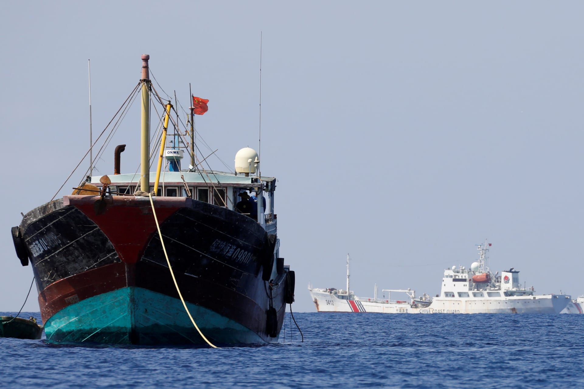 <p>China Coast Guard vessels patrol past a Chinese fishing vessel at the disputed Scarborough Shoal, April 5, 2017. </p>
