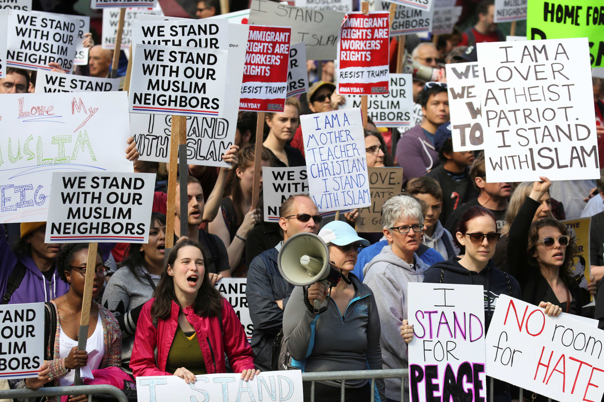 <p>Counter-protesters hold signs and shout slogans during an anti-Sharia rally in Seattle.</p>
