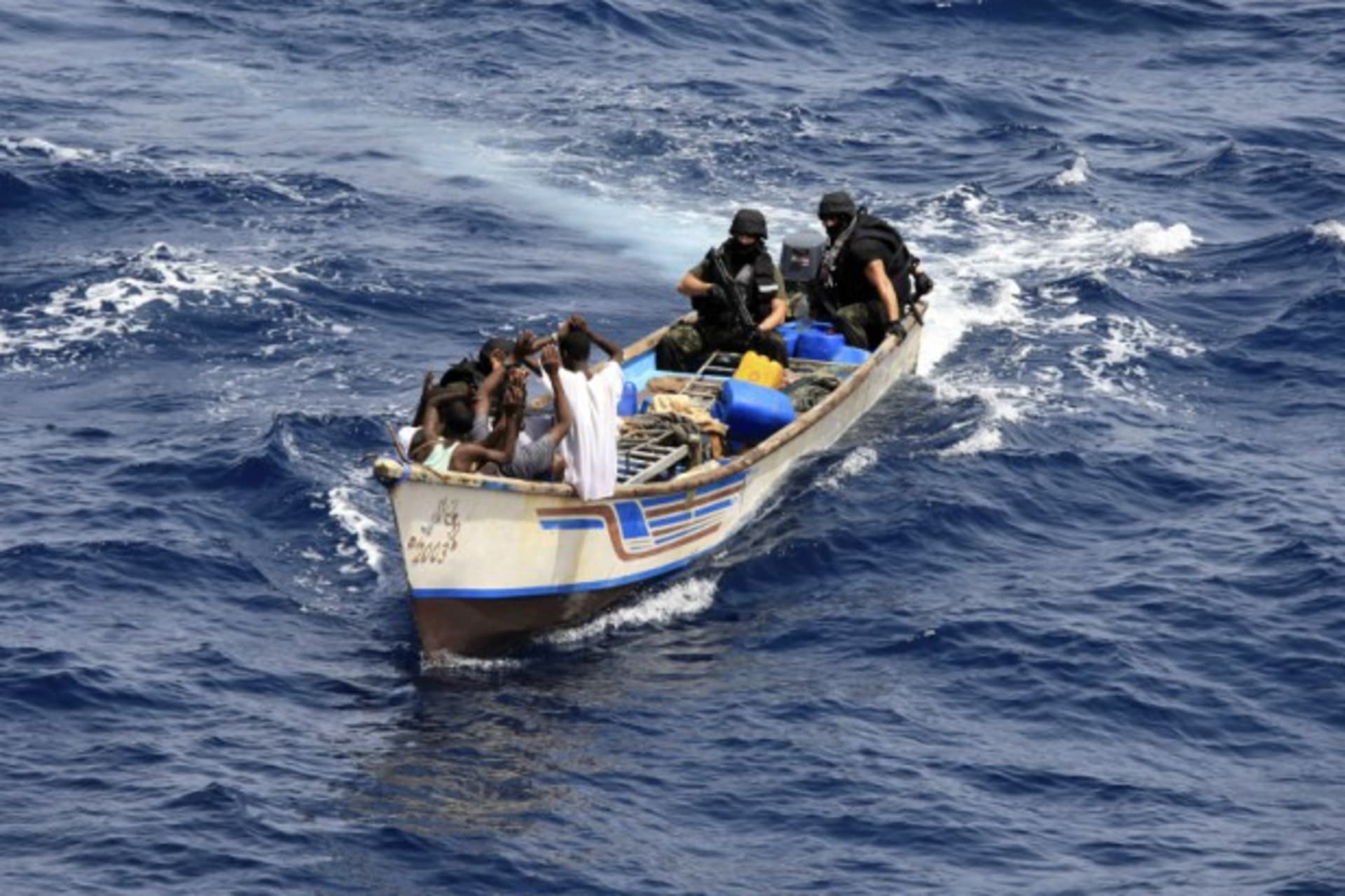 <p>Marines from NATO’s Portuguese frigate Corte-Real arrest pirates on their skiff in the Gulf of Aden June 22, 2009.</p>
