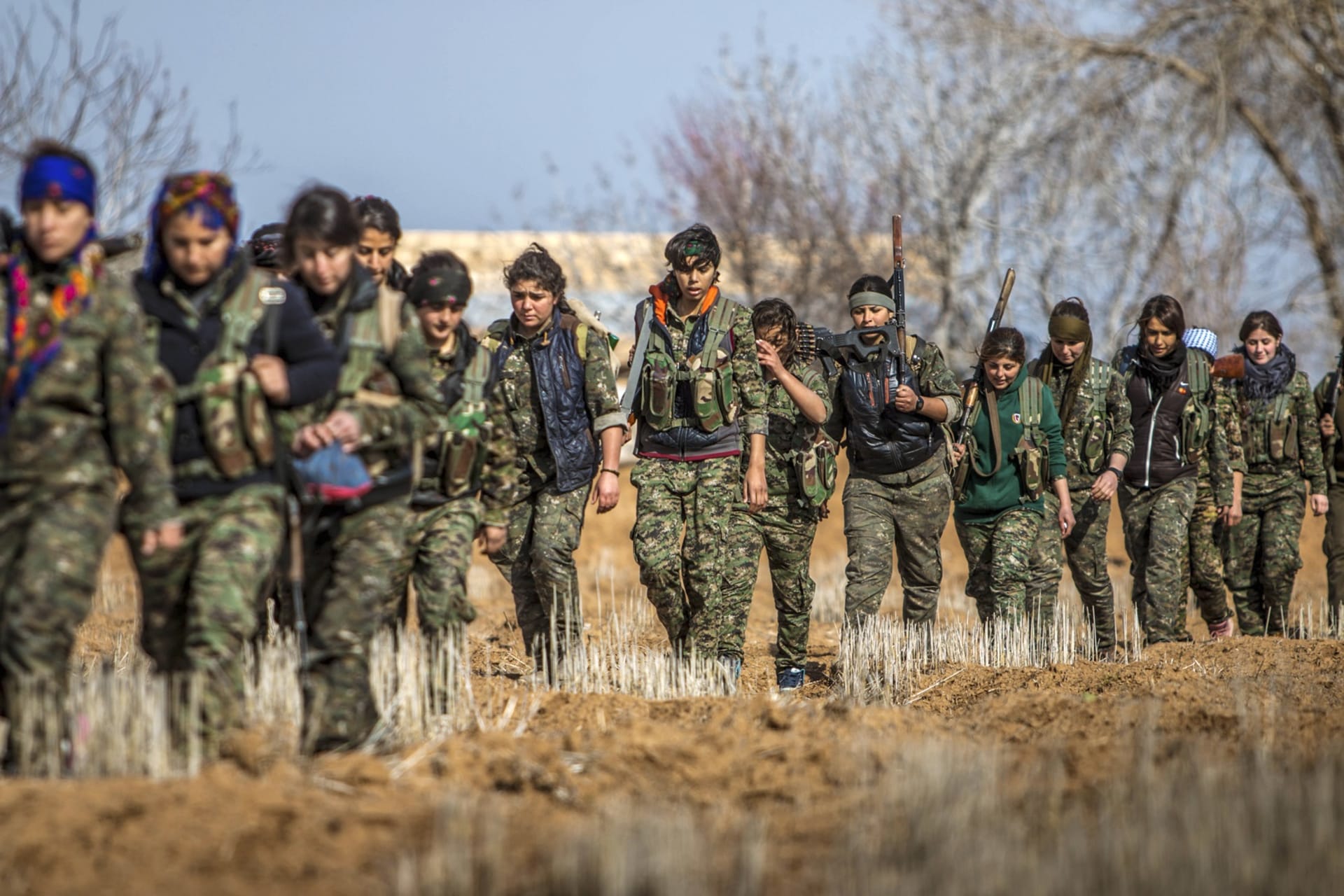 <p>Female fighters of the Kurdish People’s Protection Units (YPG) carry their weapons as they walk in the western countryside of Ras al-Ain January 25, 2015. </p>
