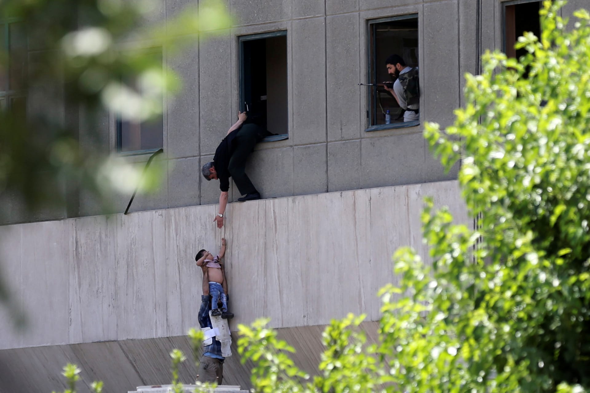 <p>A boy is evacuated from the Iranian parliament during an attack.</p>
