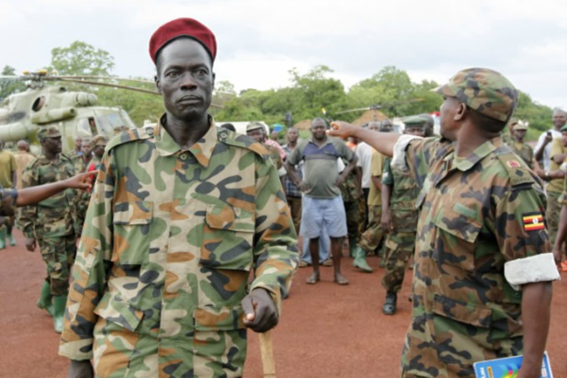 <p>Lord’s Resistance Army (LRA) commander Caesar Achellam (C) is escorted by members of the Ugandan army on arrival at the army operation base in Nera in South Sudan May 13, 2012, after he was captured by Ugandan soldiers tracking down LRA fugitive leaders.</p>
