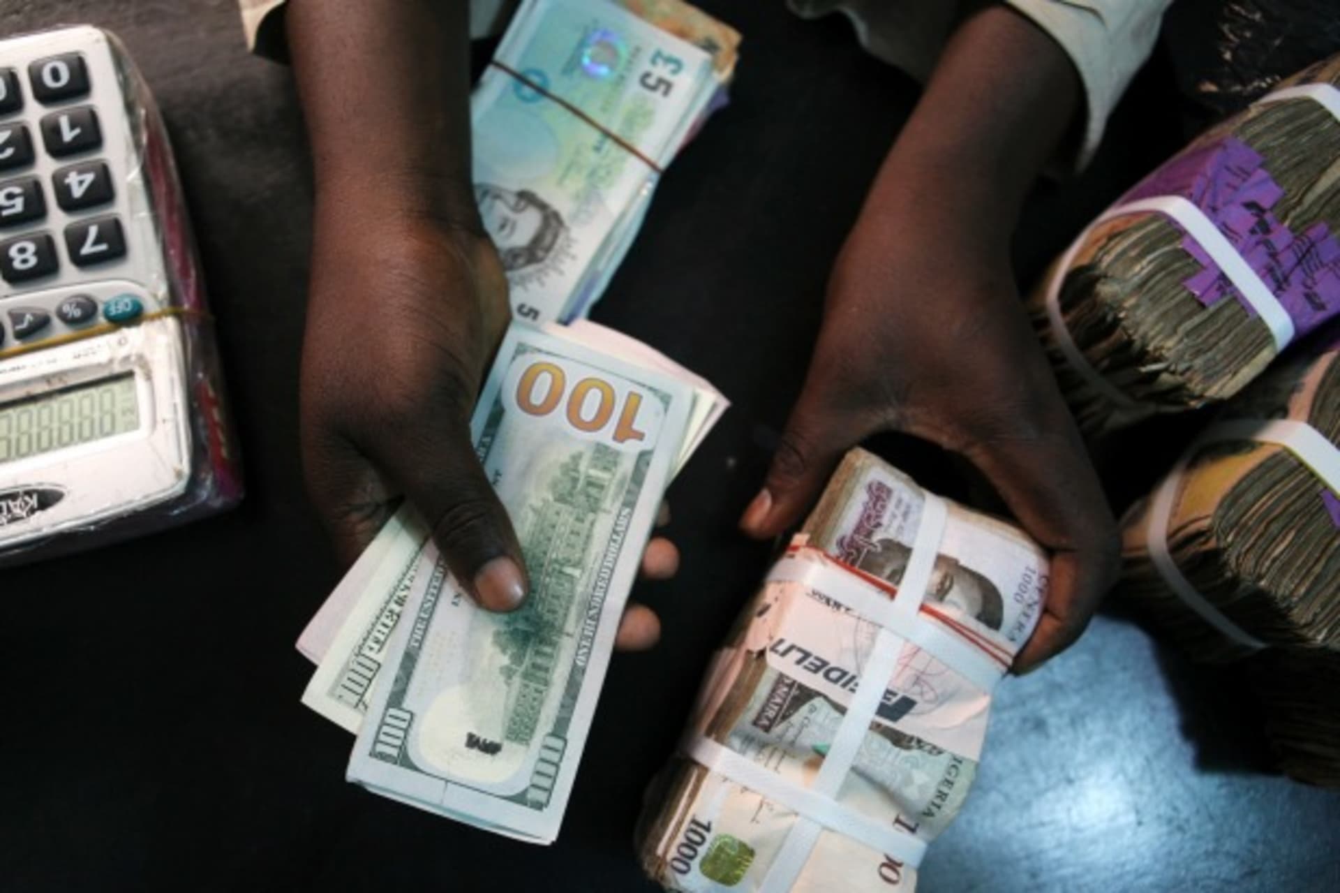 <p>A trader changes dollars for Naira at a currency exchange store in Lagos, February 12, 2015.</p>
