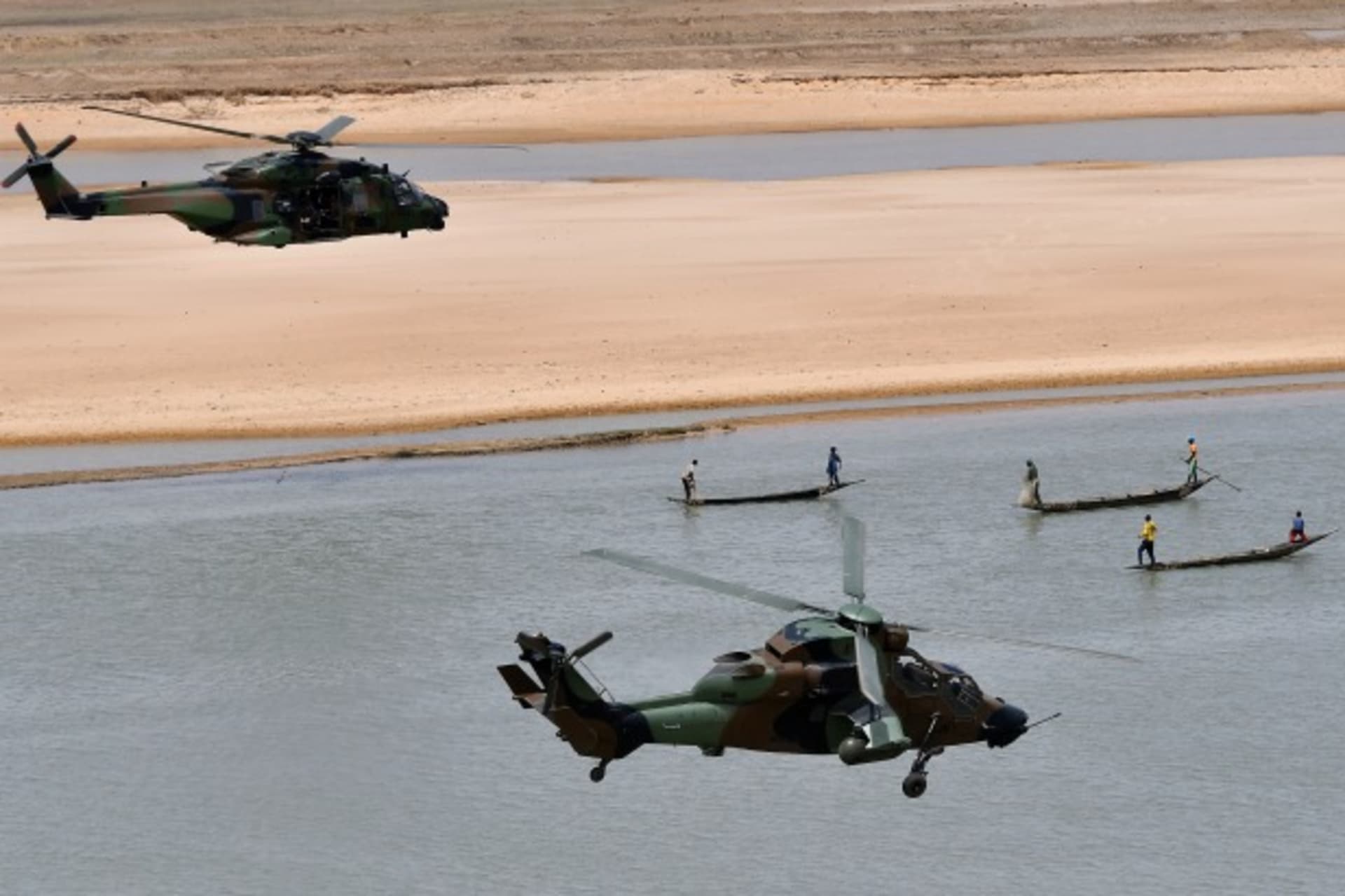<p>French President Emmanuel Macron’s helicopter (upper) flies over Gao as he visits French troops in Africa’s Sahel region in Gao, northern Mali, 19 May 2017.</p>
