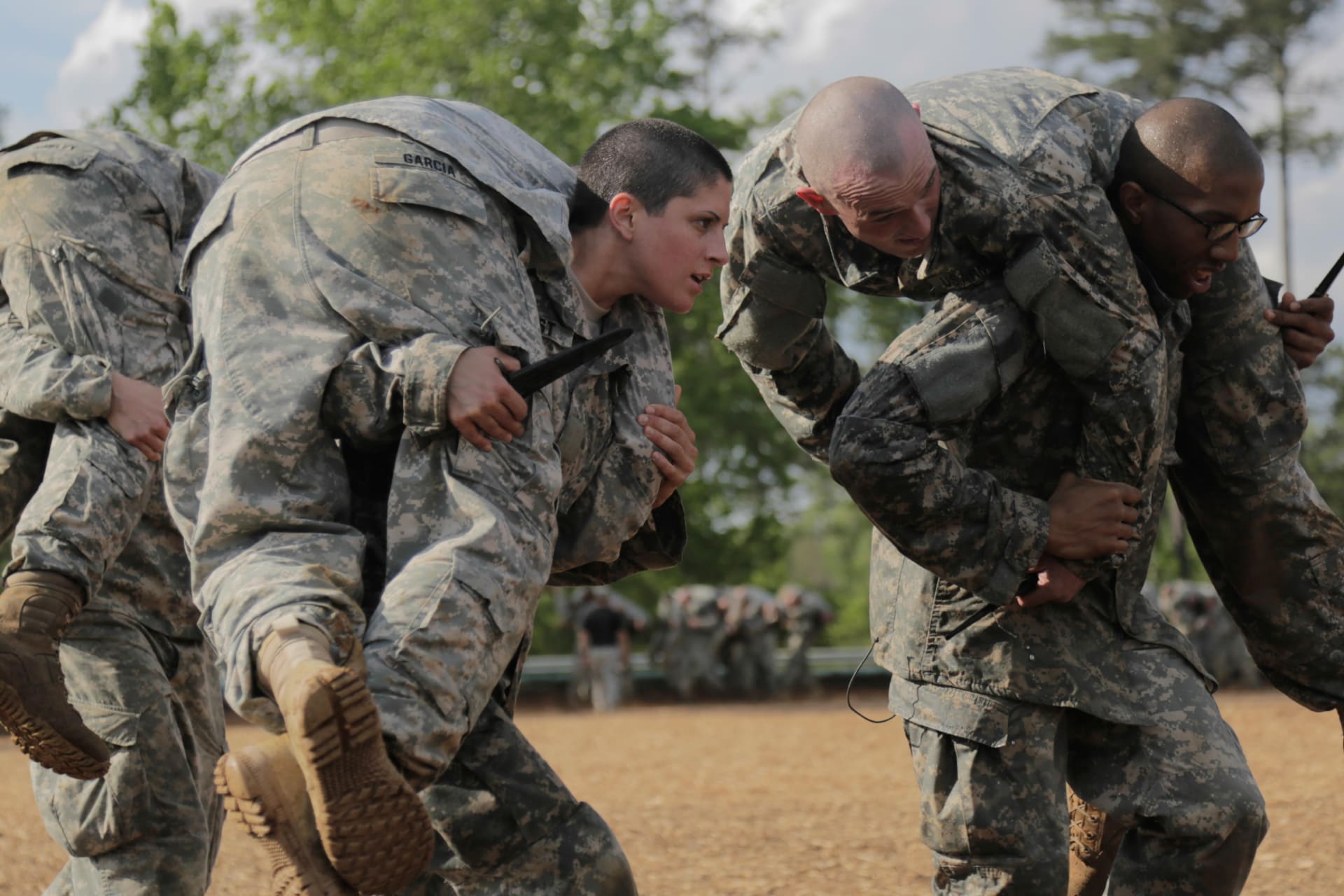 <p>Then U.S. Army First Lieutenant Kirsten Griest (C) and fellow soldiers participate in combatives training during the Ranger Course on Fort Benning, Georgia.</p>
