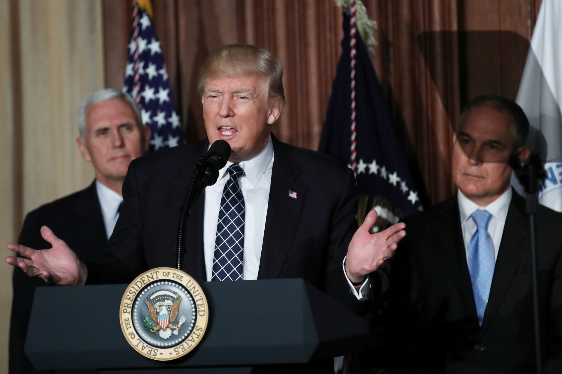 <p>President Donald Trump speaks between Vice President Mike Pence and EPA Administrator Scott Pruitt prior to signing an executive order on “energy independence,” eliminating Obama-era climate change regulations, during an event at the EPA</p>
