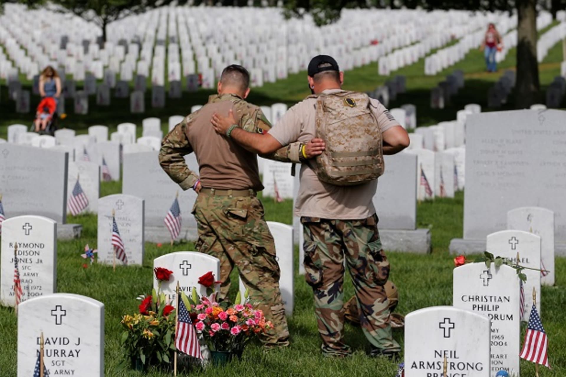 <p>U.S. Army soldiers visit the grave of a fallen friend at Arlington National Cemetery </p>

