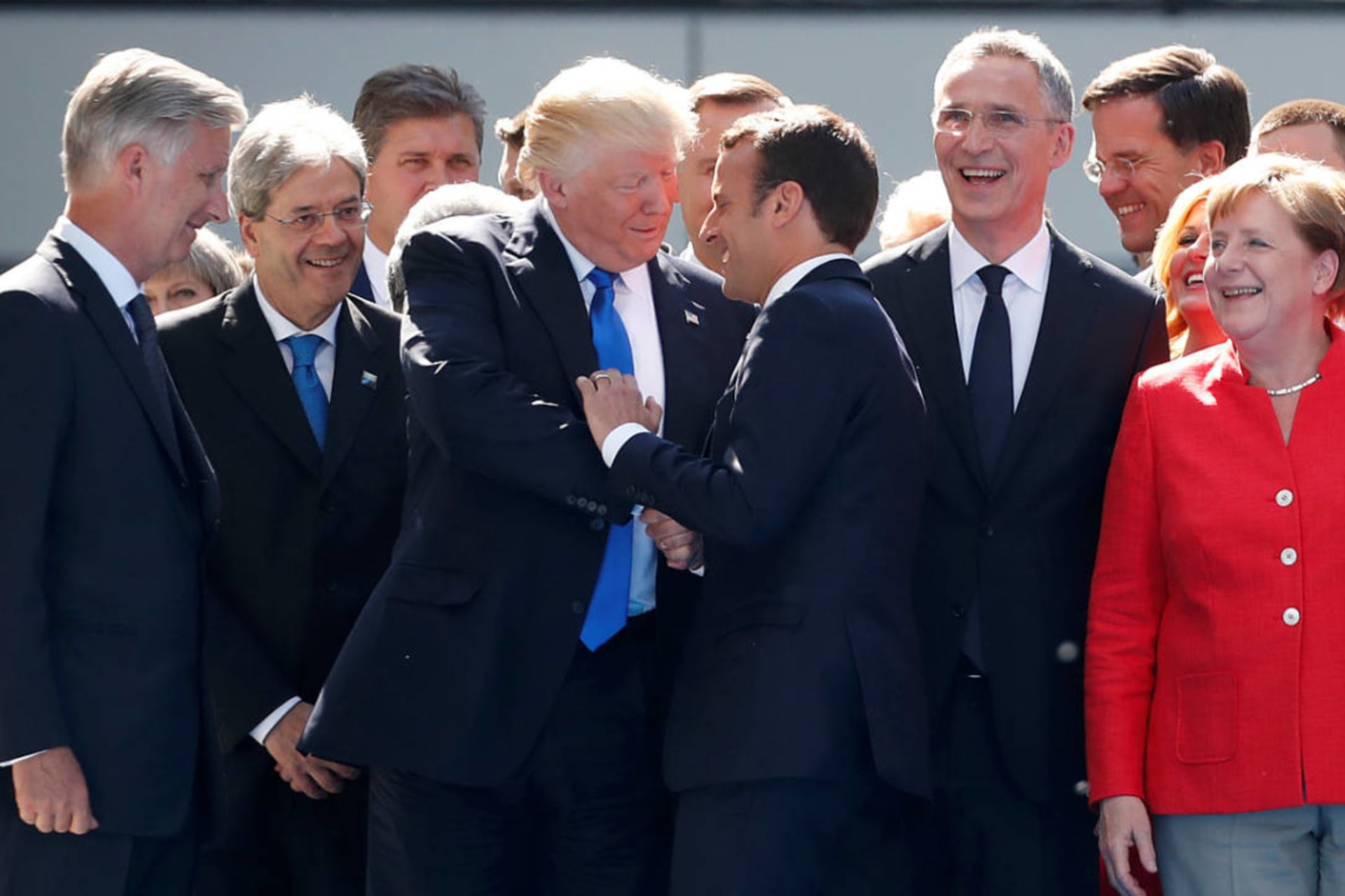 <p>U.S. President Donald Trump shakes hands with French President Emmanuel Macron as NATO member leaders pose for a family picture before the start of their summit in Brussels, Belgium, May 25, 2017.</p>

