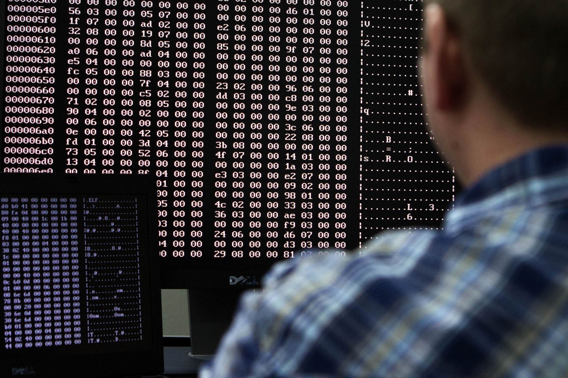 <p>An analyst looks at code in the malware lab of a cyber security defense lab at the Idaho National Laboratory</p>
