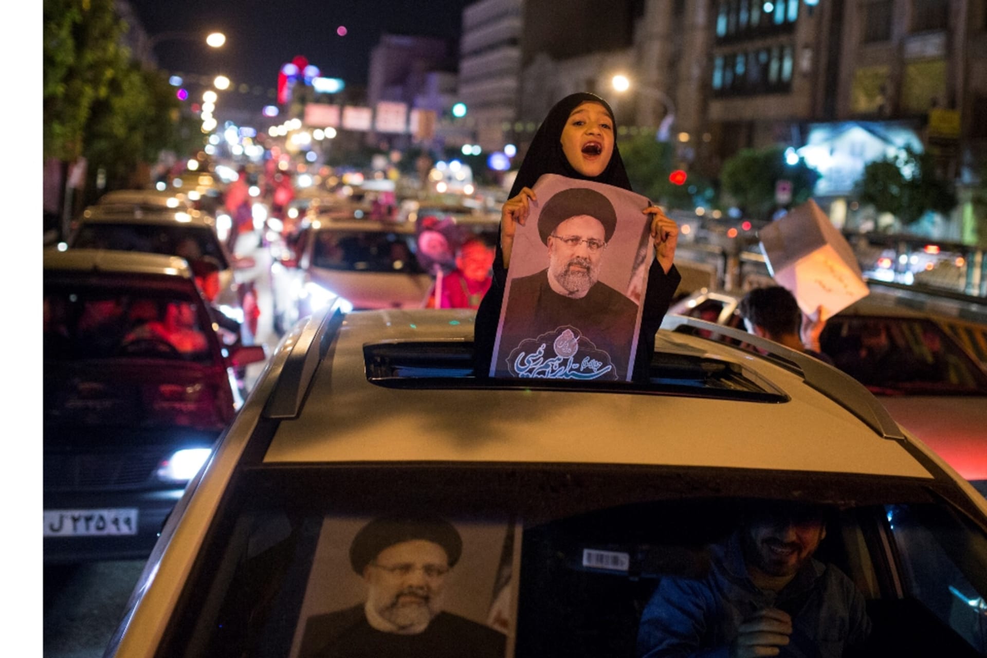 <p>A girl holds a poster of Iranian presidential candidate Ebrahim Raisi during a campaign rally in Tehran, Iran. </p>
