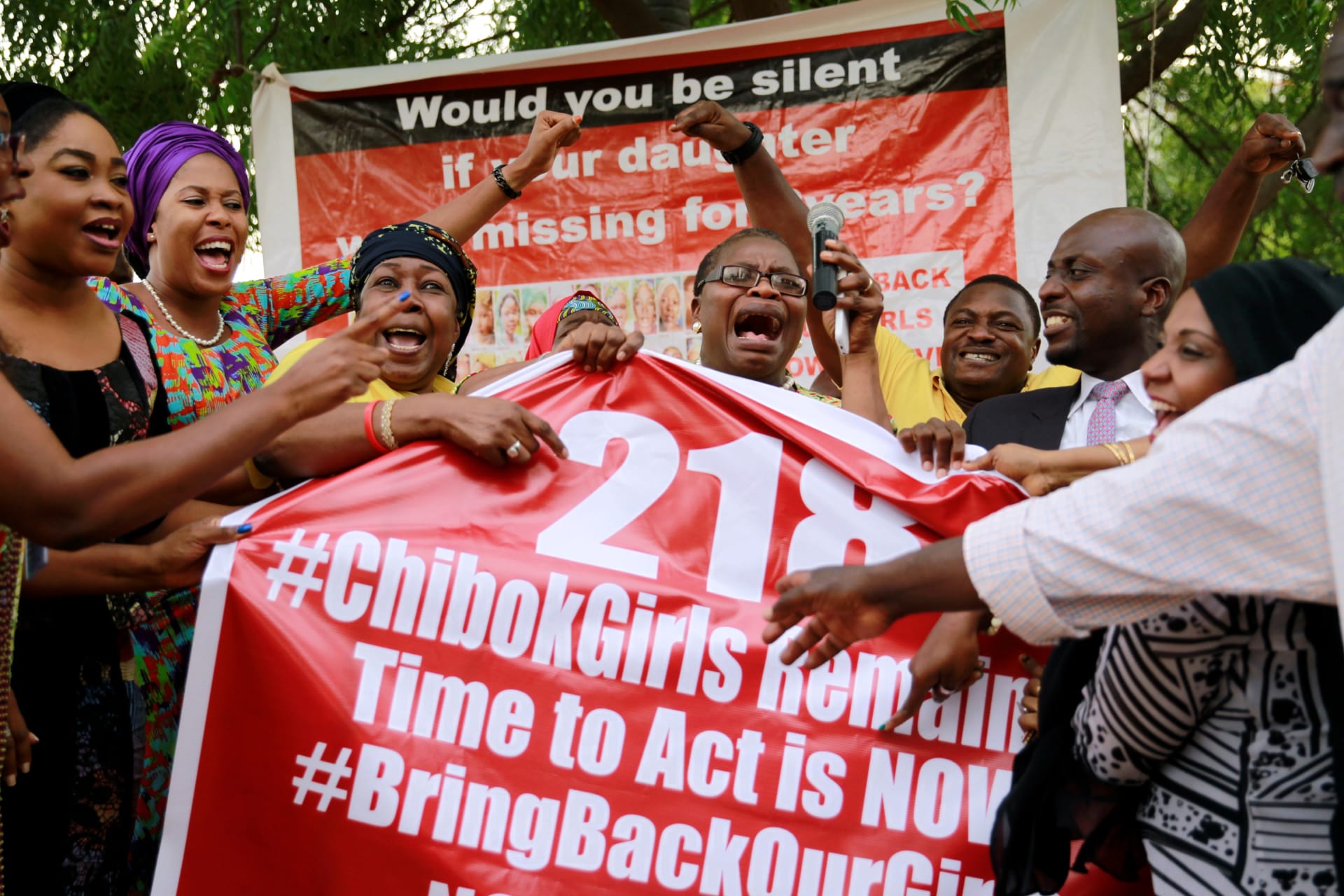 <p>Members of the #BringBackOurGirls (#BBOG) campaign react on the presentation of a banner which shows “218”, instead of the previous “219”, referring to kidnapped Chibok school girls, during a sit-out in Abuja, Nigeria May 18, 2016.</p>
