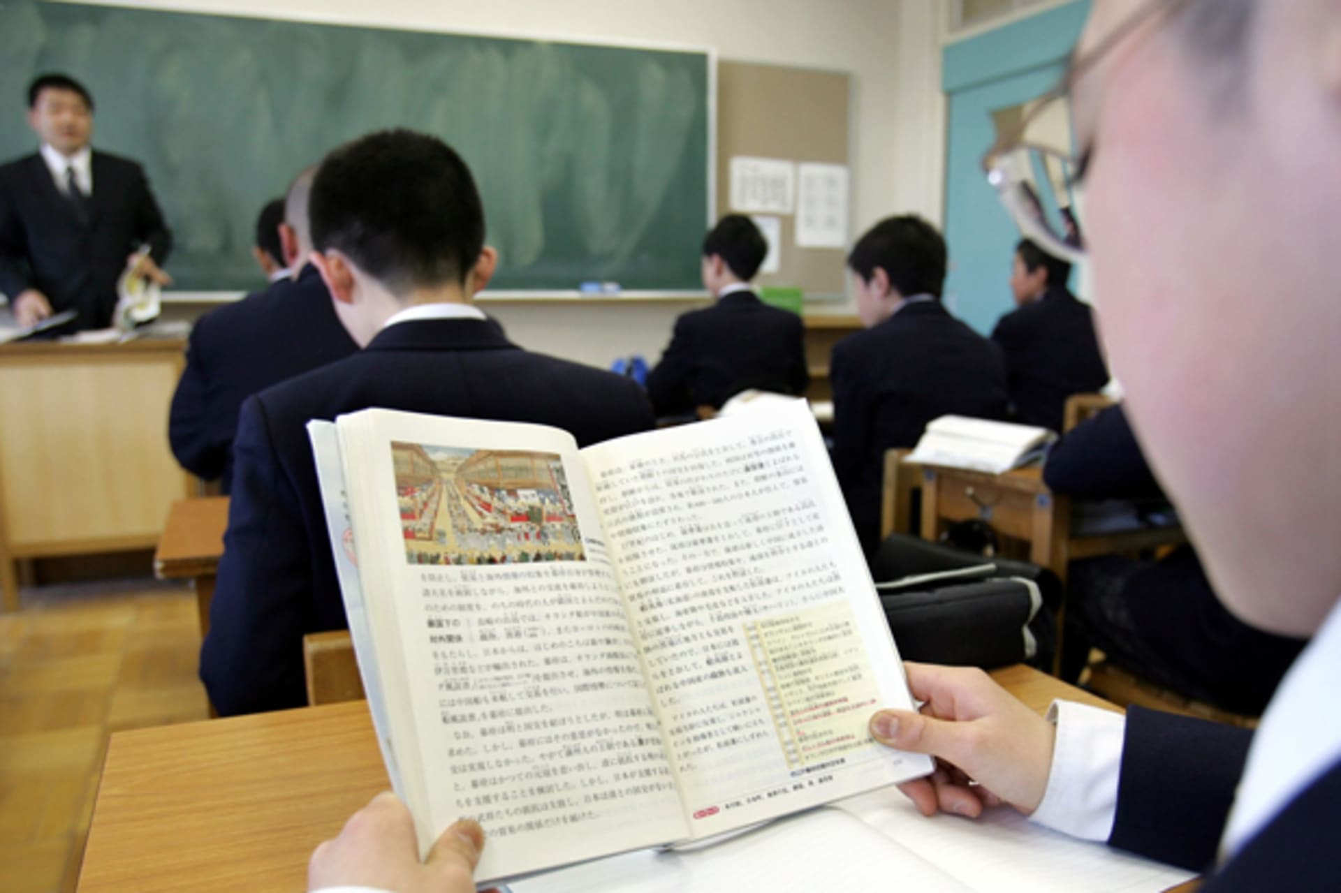 <p>A Japanese student reads a history textbook in a classroom at a junior high school in Tochigi, north of Tokyo, April 14, 2005.</p>
