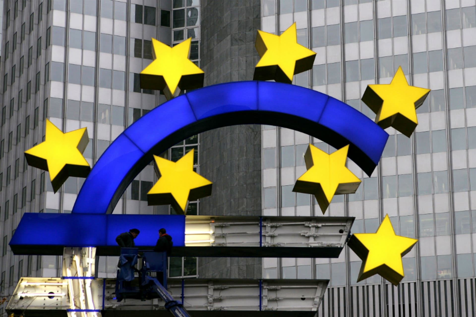 <p>Workers repair the euro sign in front of the European Central Bank headquarters in Germany.</p>

