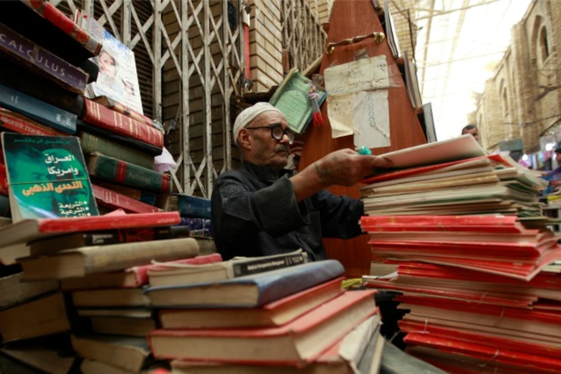 <p>A vendor sells books at Mutanabi Street in Baghdad (Mohammed Ameen/Reuters).</p>
