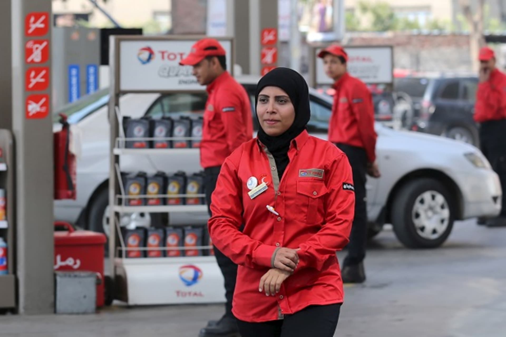 A female employee is seen as she works at a petrol station in Cairo