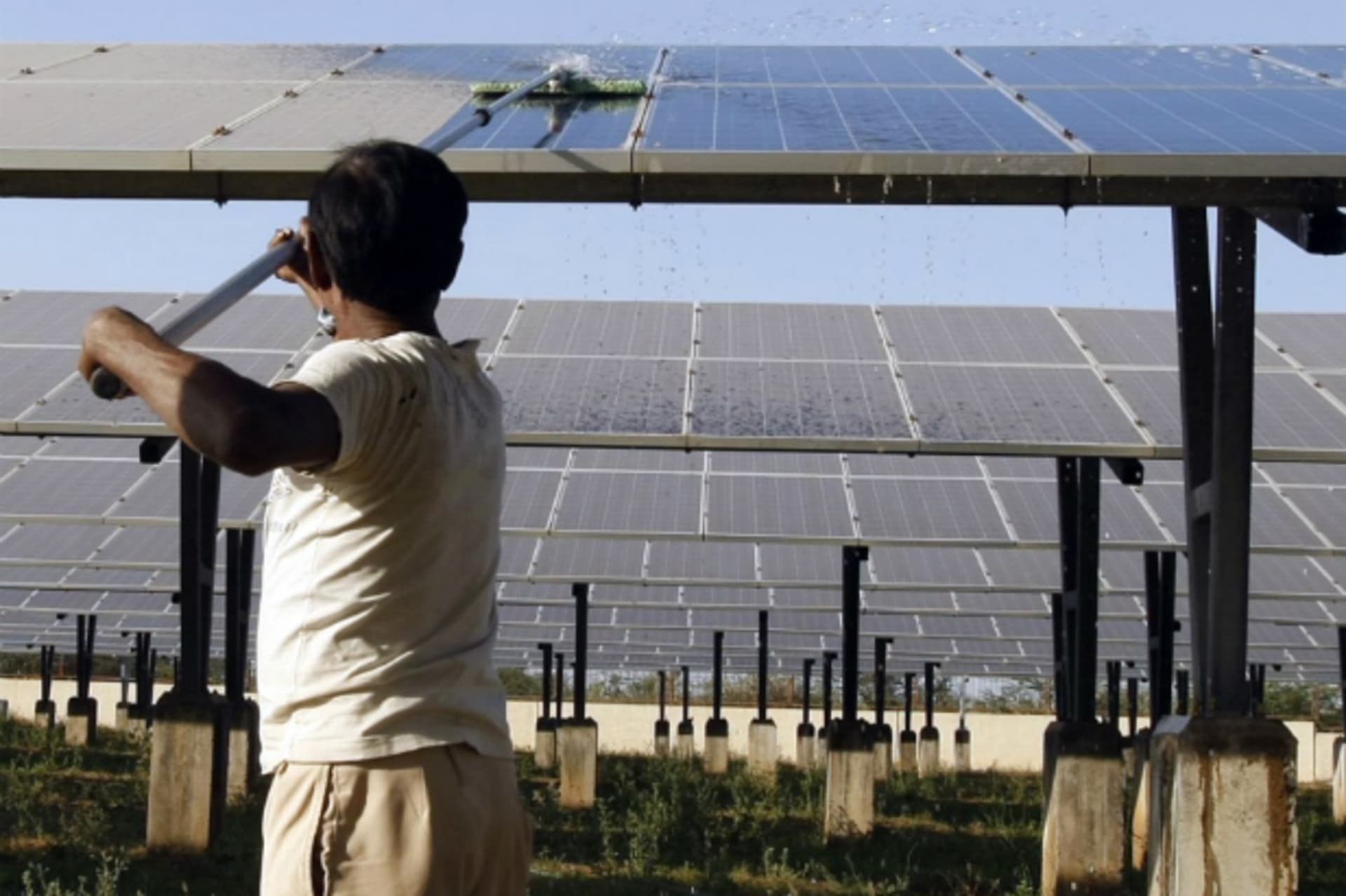 <p>A worker cleans photovoltaic solar panels inside a solar power plant at Raisan village near Gandhinagar, in the western Indian state of Gujarat (Reuters/Amit Dave)</p>