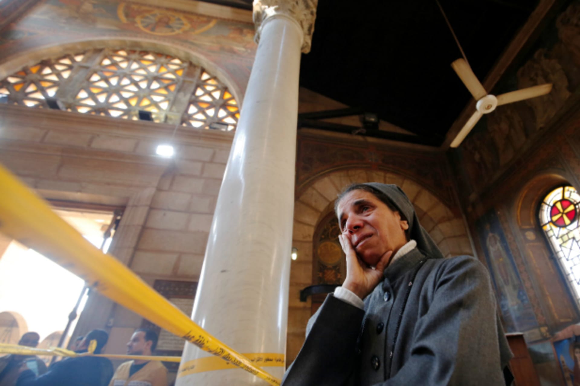 <p>A nun cries as she stands at the scene inside Cairo’s Coptic cathedral, following a bombing, in Egypt (Amr Abdallah Dalsh/Reuters).</p>
