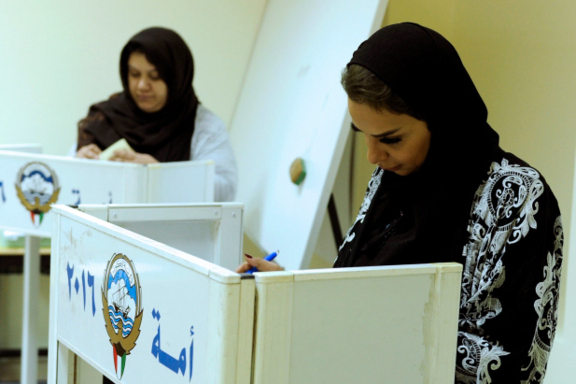 <p>Kuwaiti women cast their votes during parliamentary election in a polling station in Kuwait City, Kuwait (Stringer/Reuters).</p>
